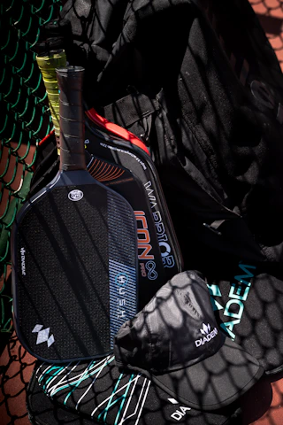 Two pickleball paddles, a hat, and a bag.