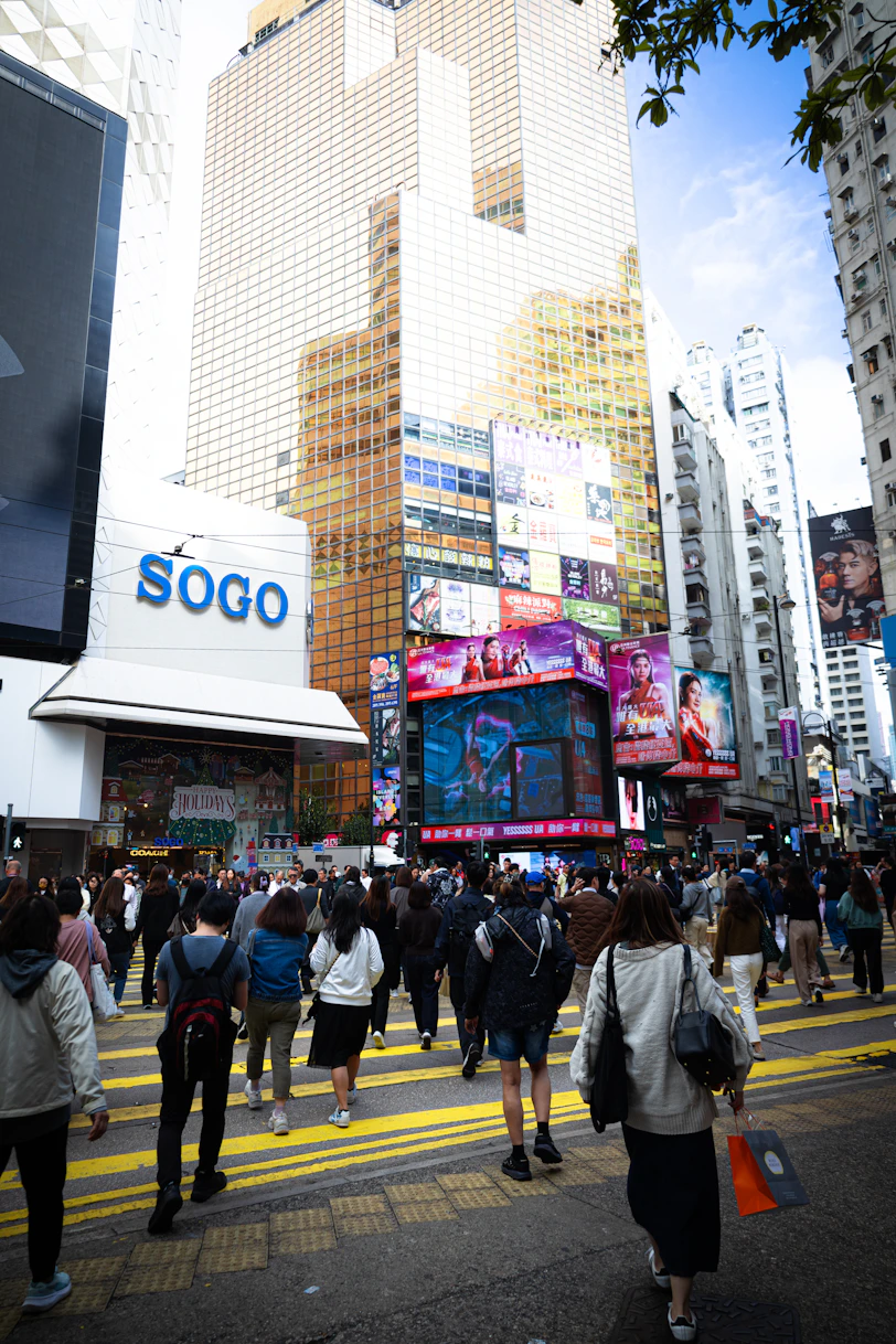 Crowded street with tall buildings and sogo store.