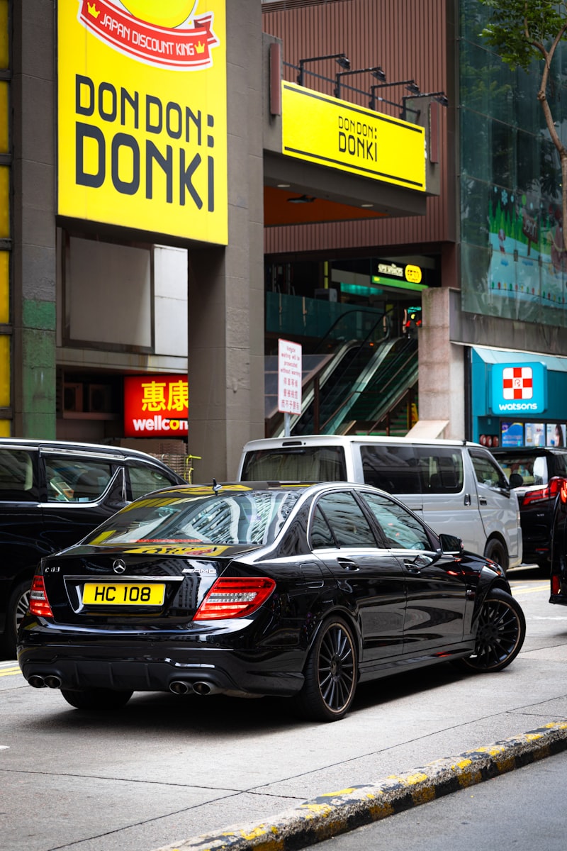 Black luxury sedan parked on an urban street