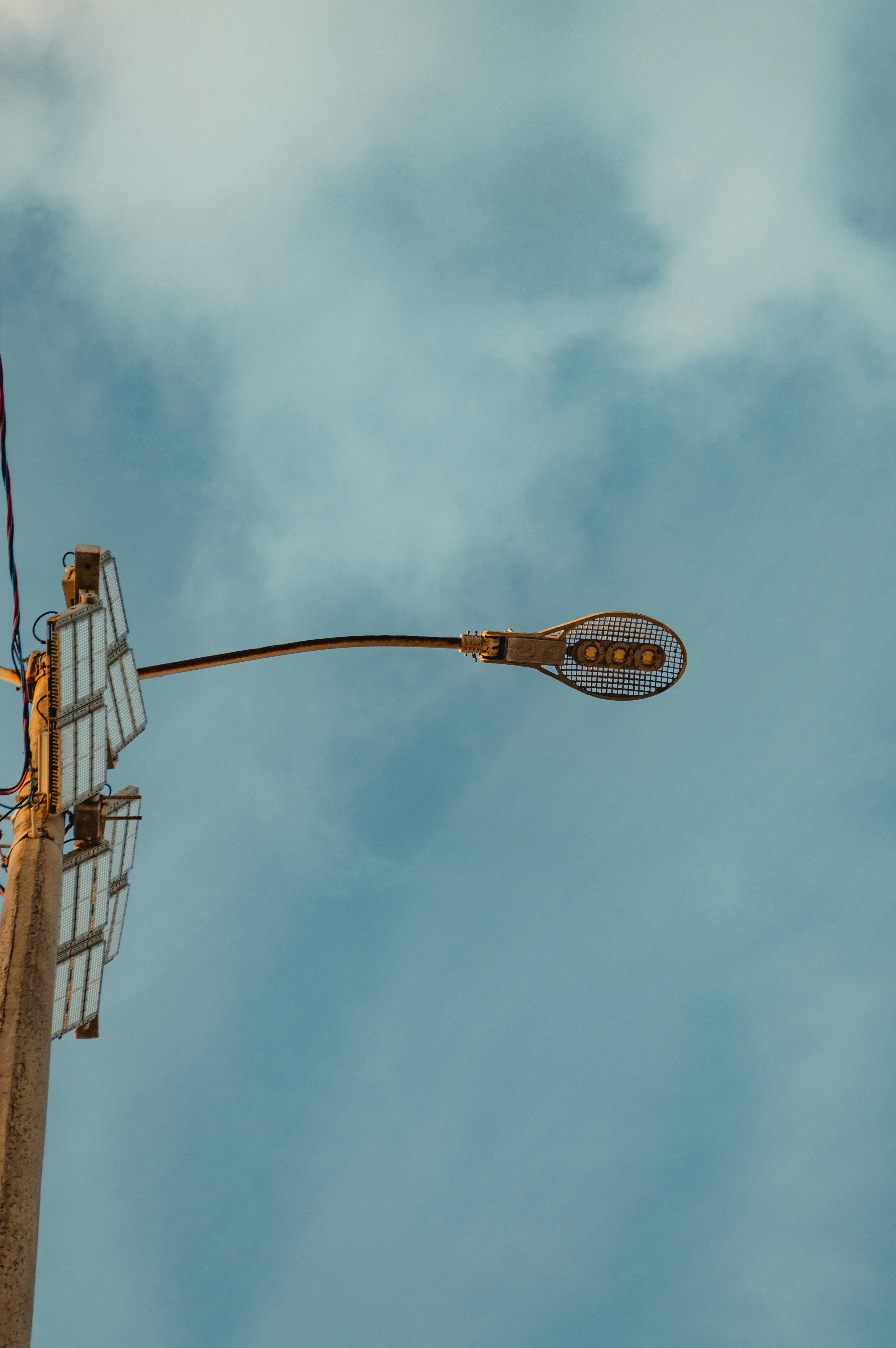 Streetlight against a cloudy sky at dusk