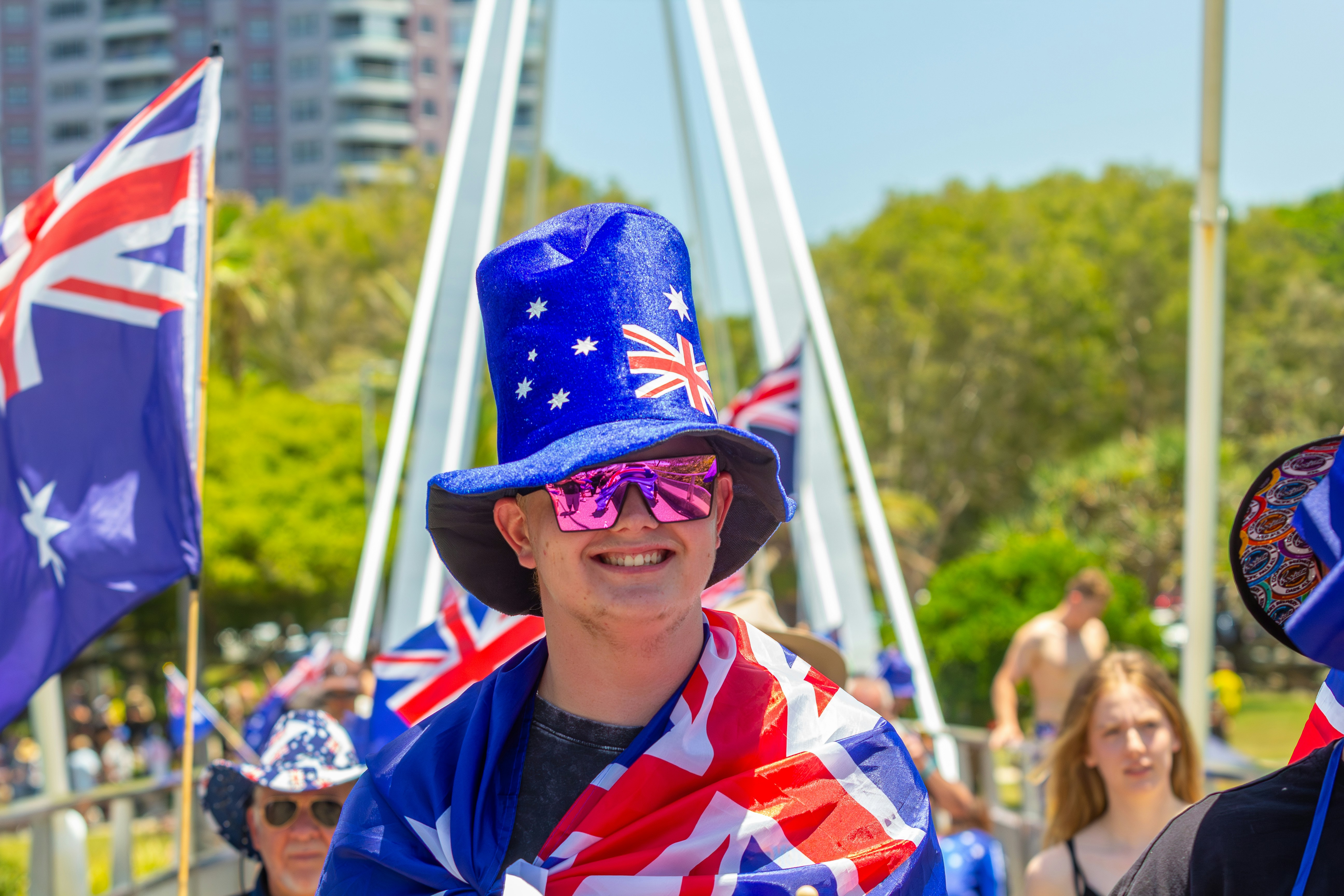 Man in australian flag hat and scarf smiles