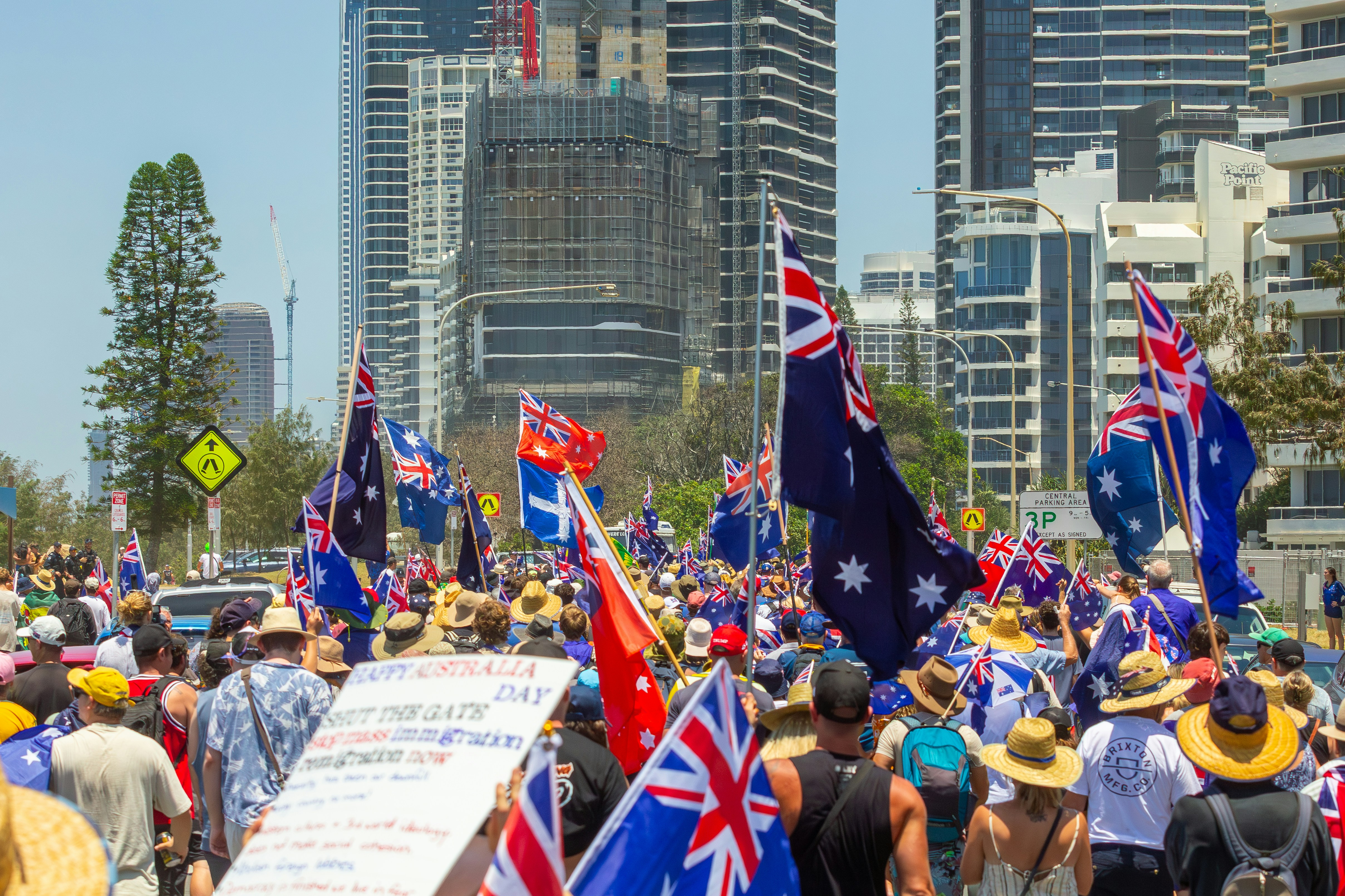 Crowd of people waving australian flags in a city