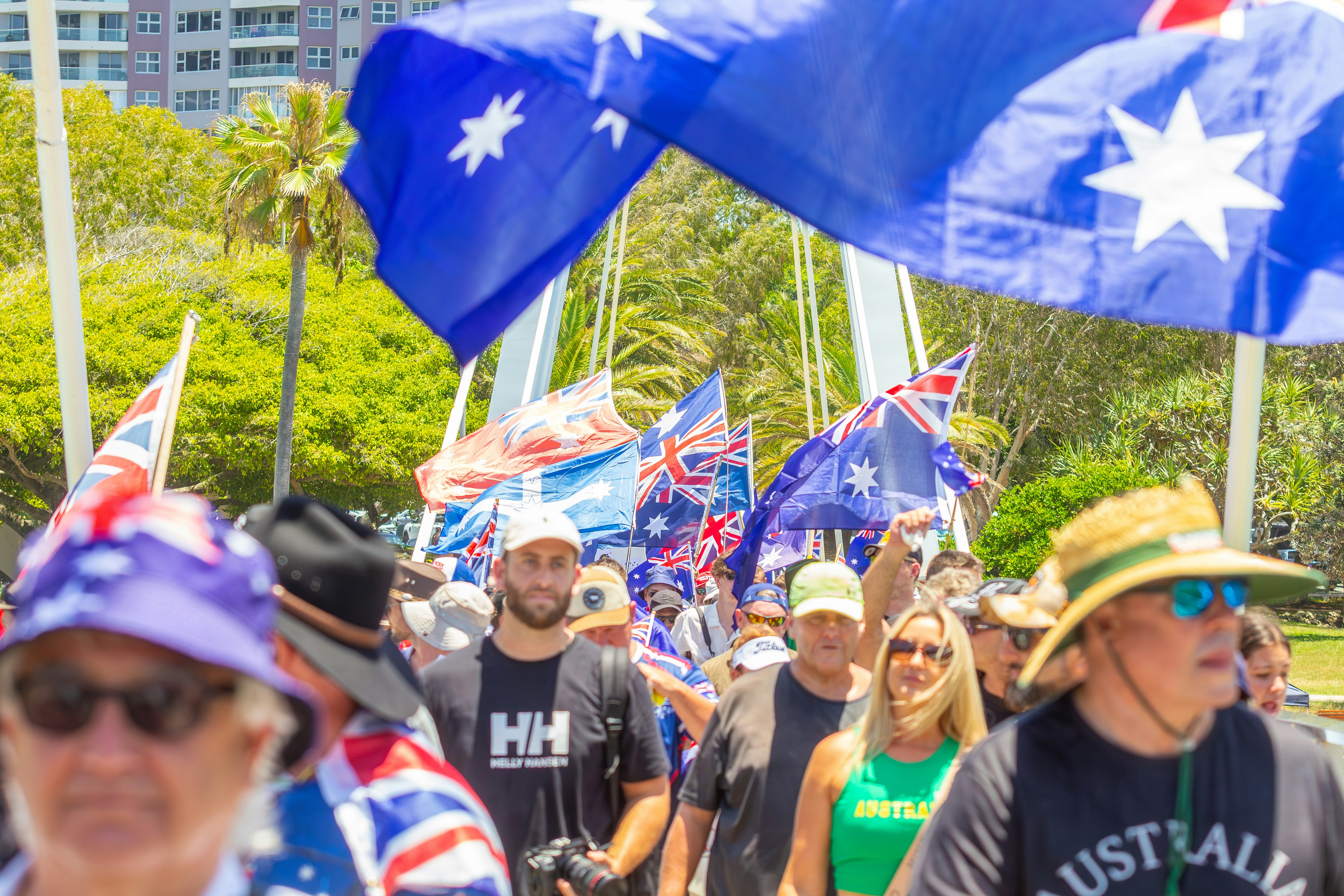 Crowd of people waving australian flags