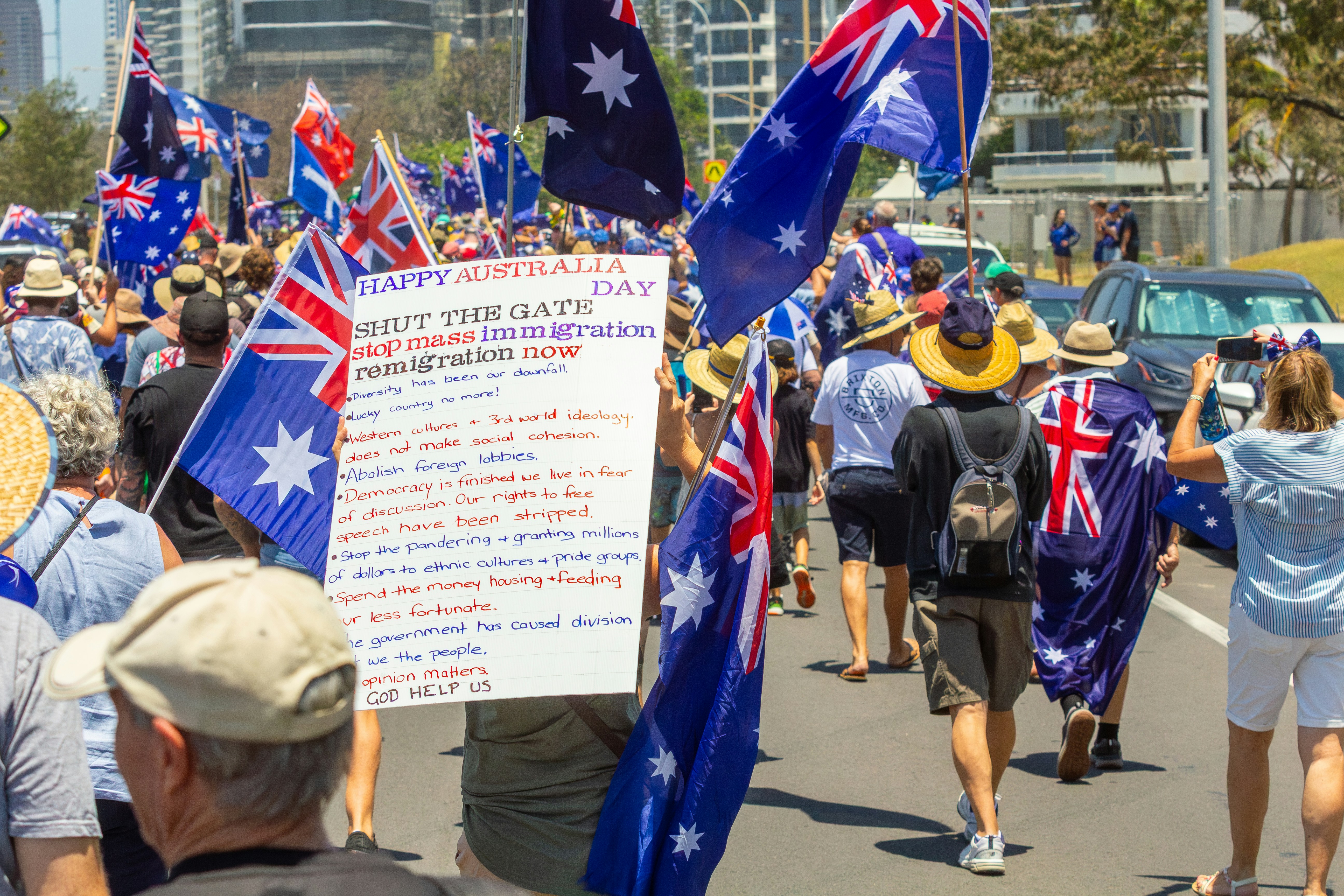 Crowd waving australian flags on a sunny day
