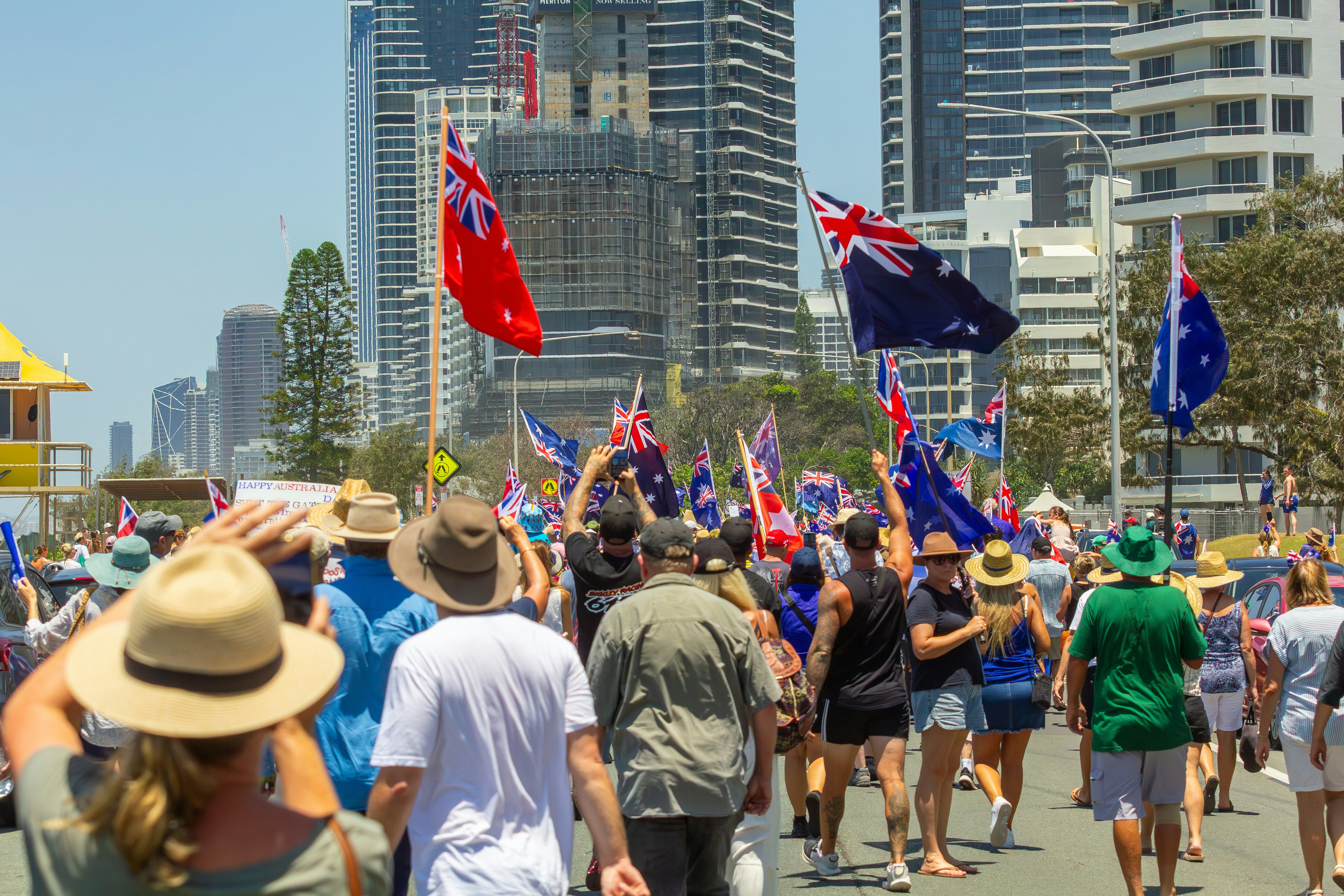 Crowd of people marching with australian flags