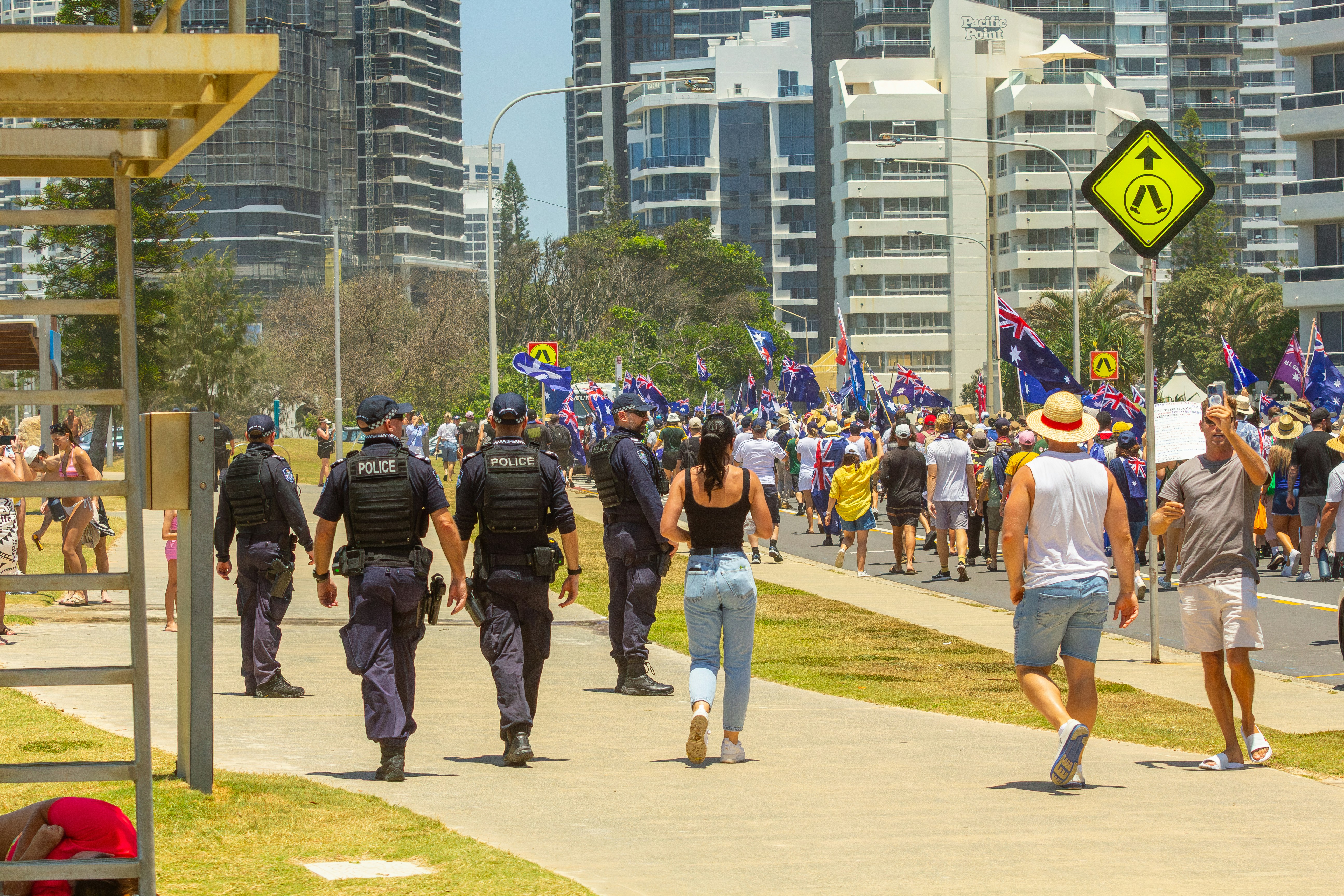 Police officers escorting a crowd in a city