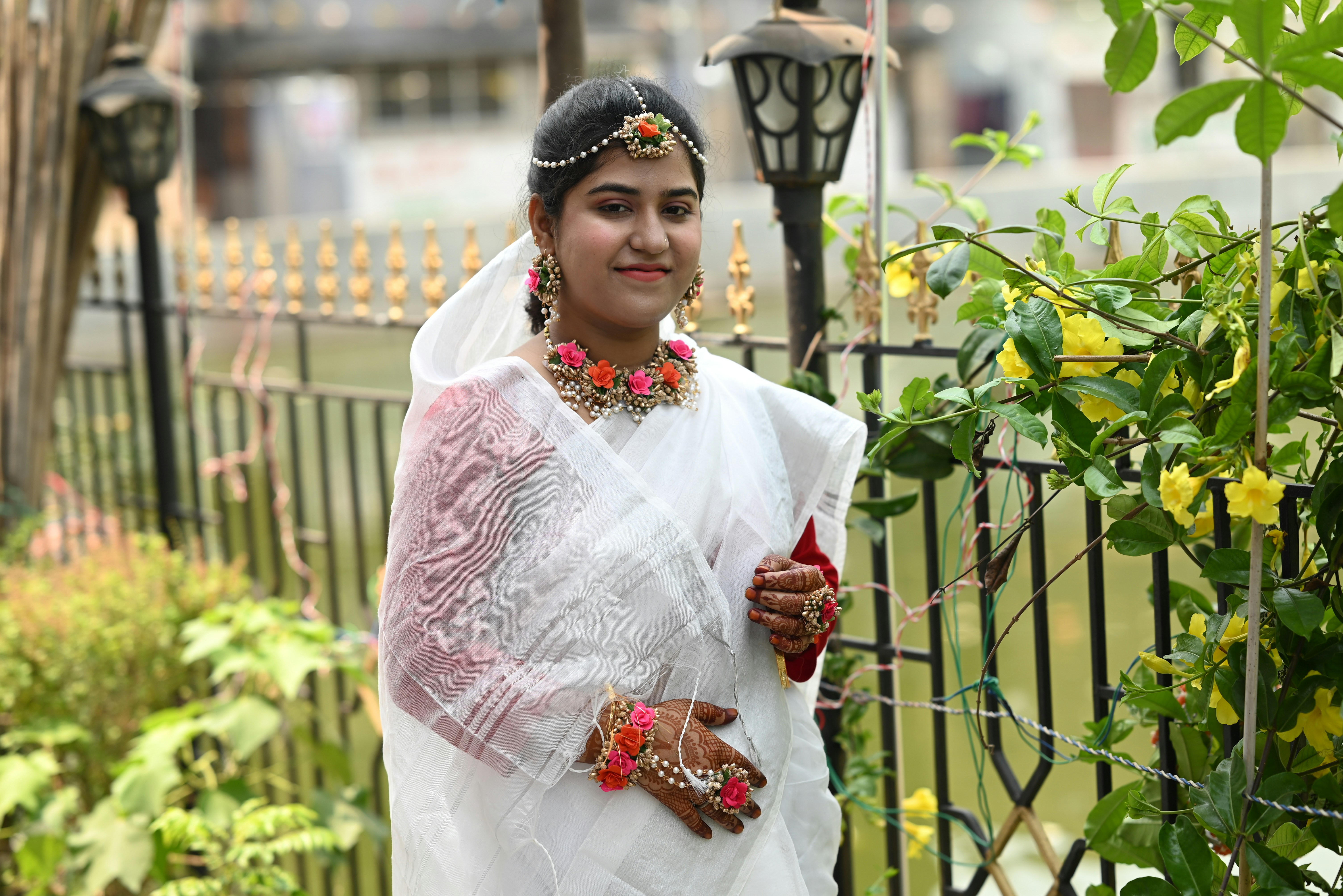 Woman in white sari with floral jewelry