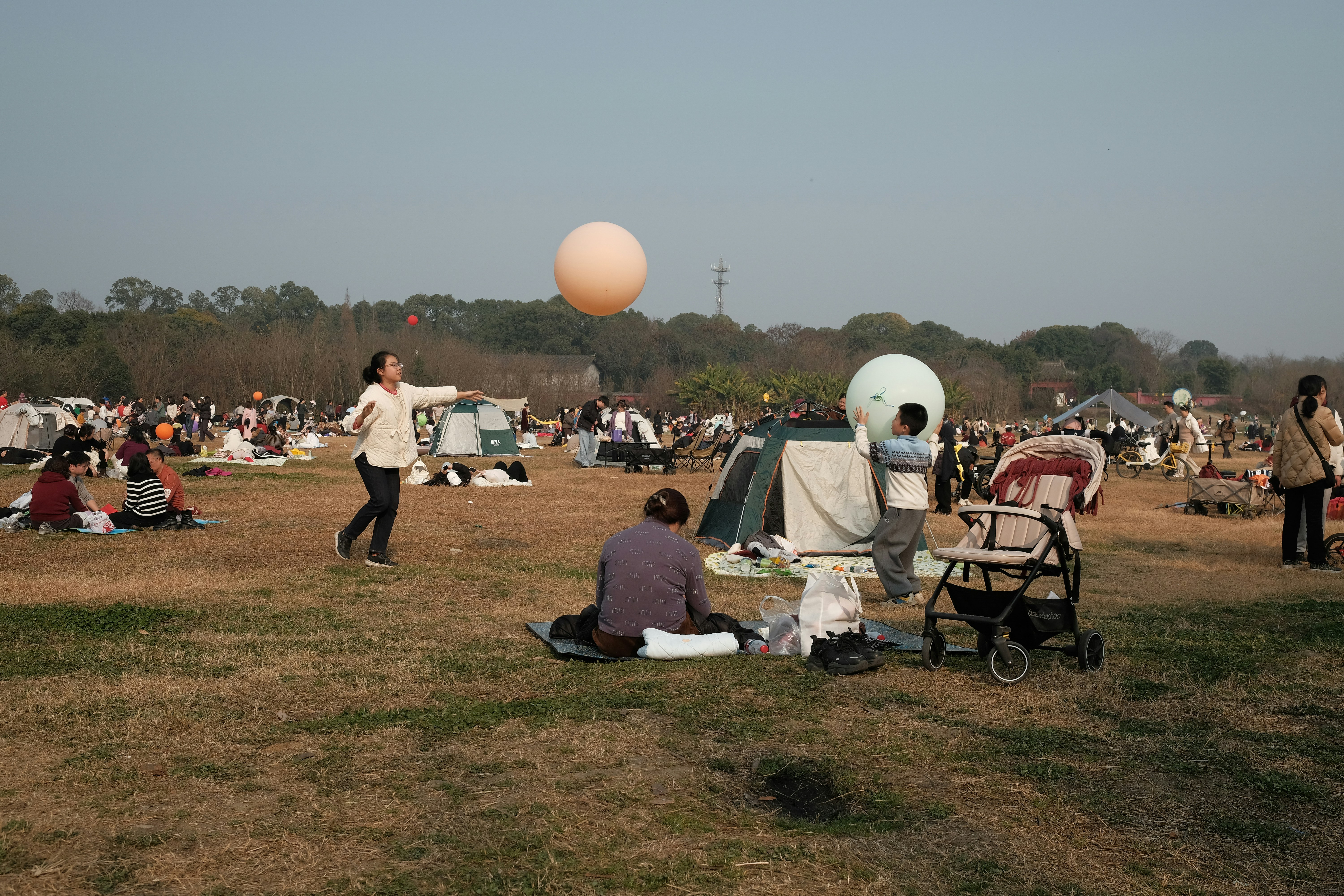 People enjoying a sunny day at an outdoor gathering