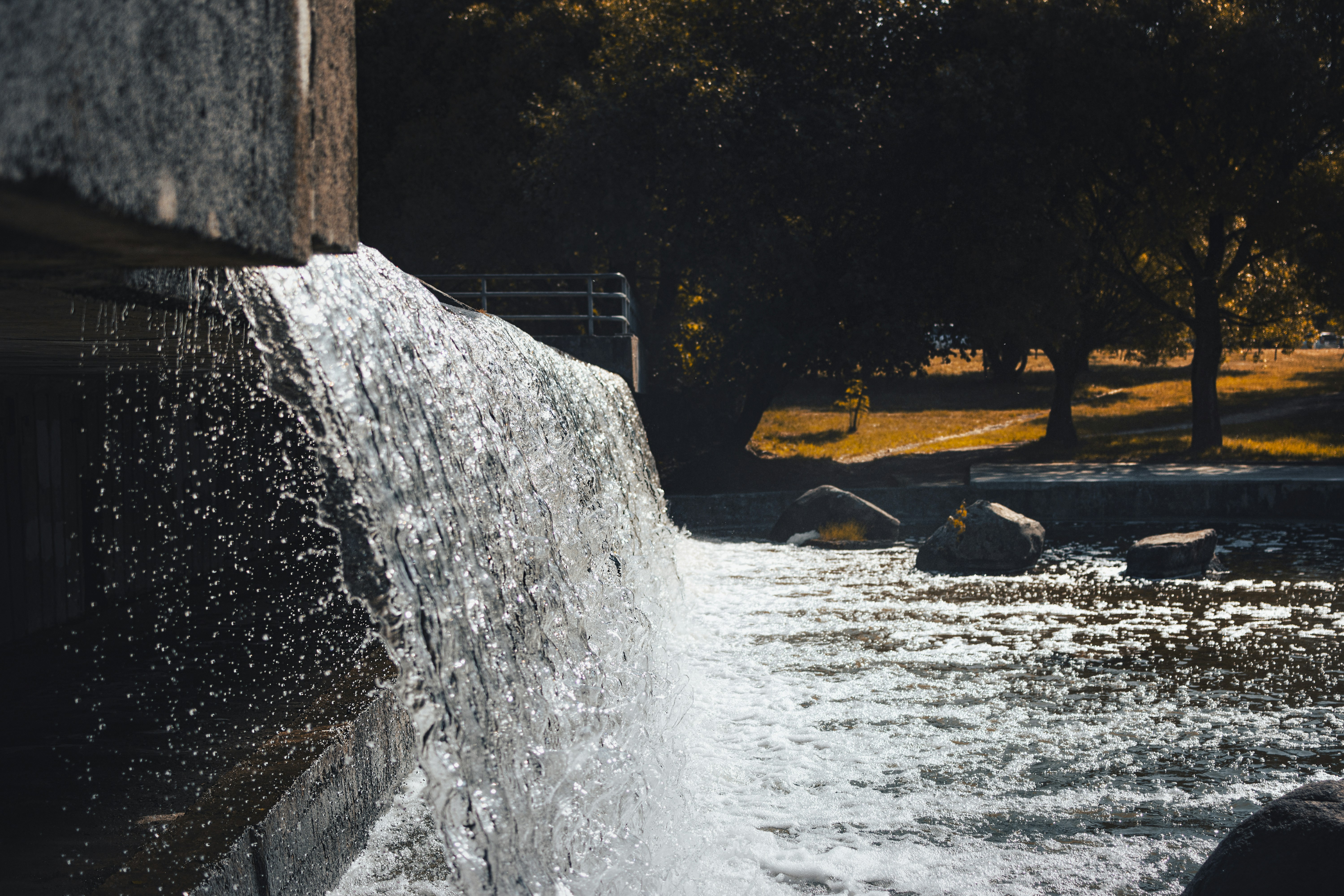Water cascades over rocks in a park