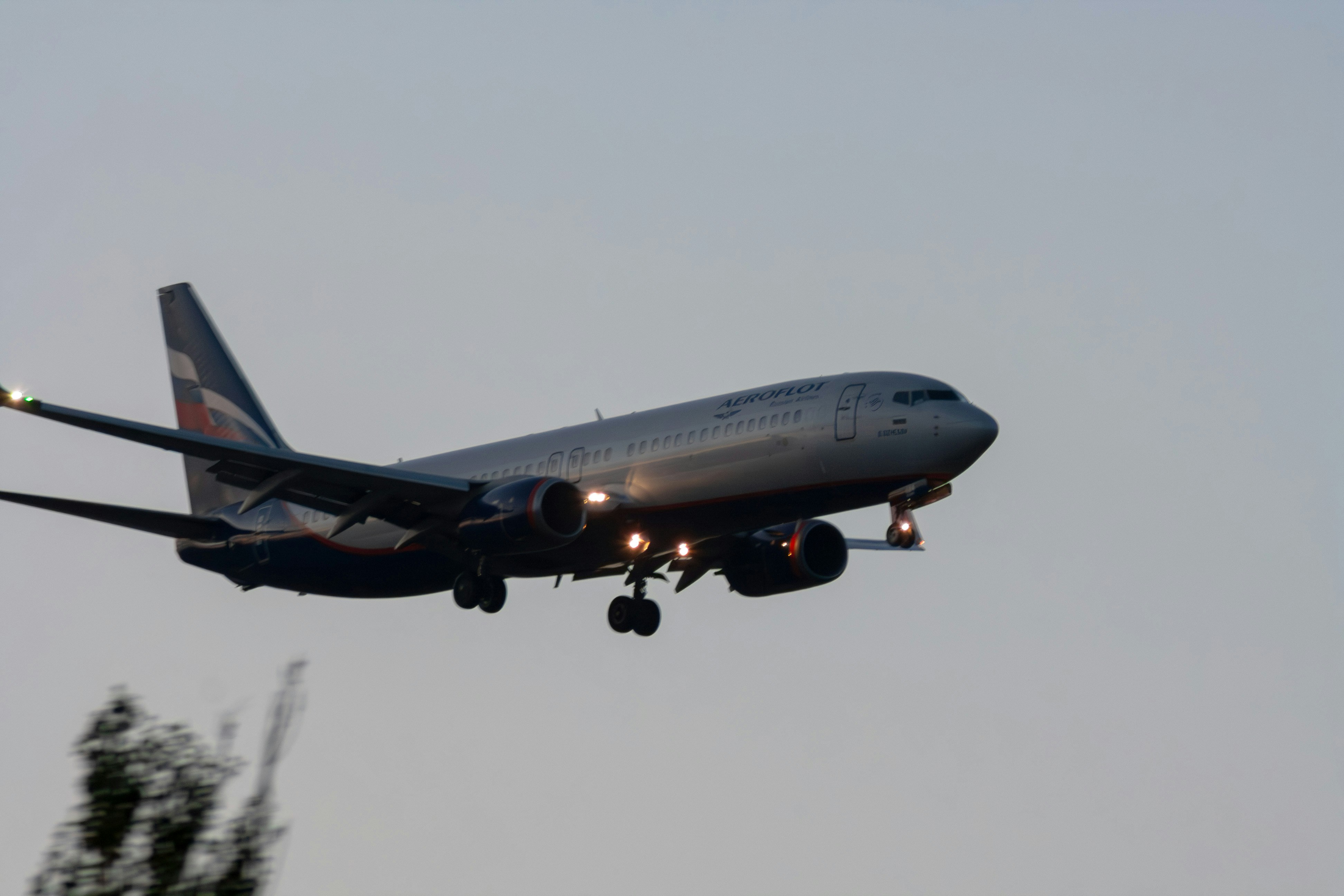 Airplane descending with landing lights on