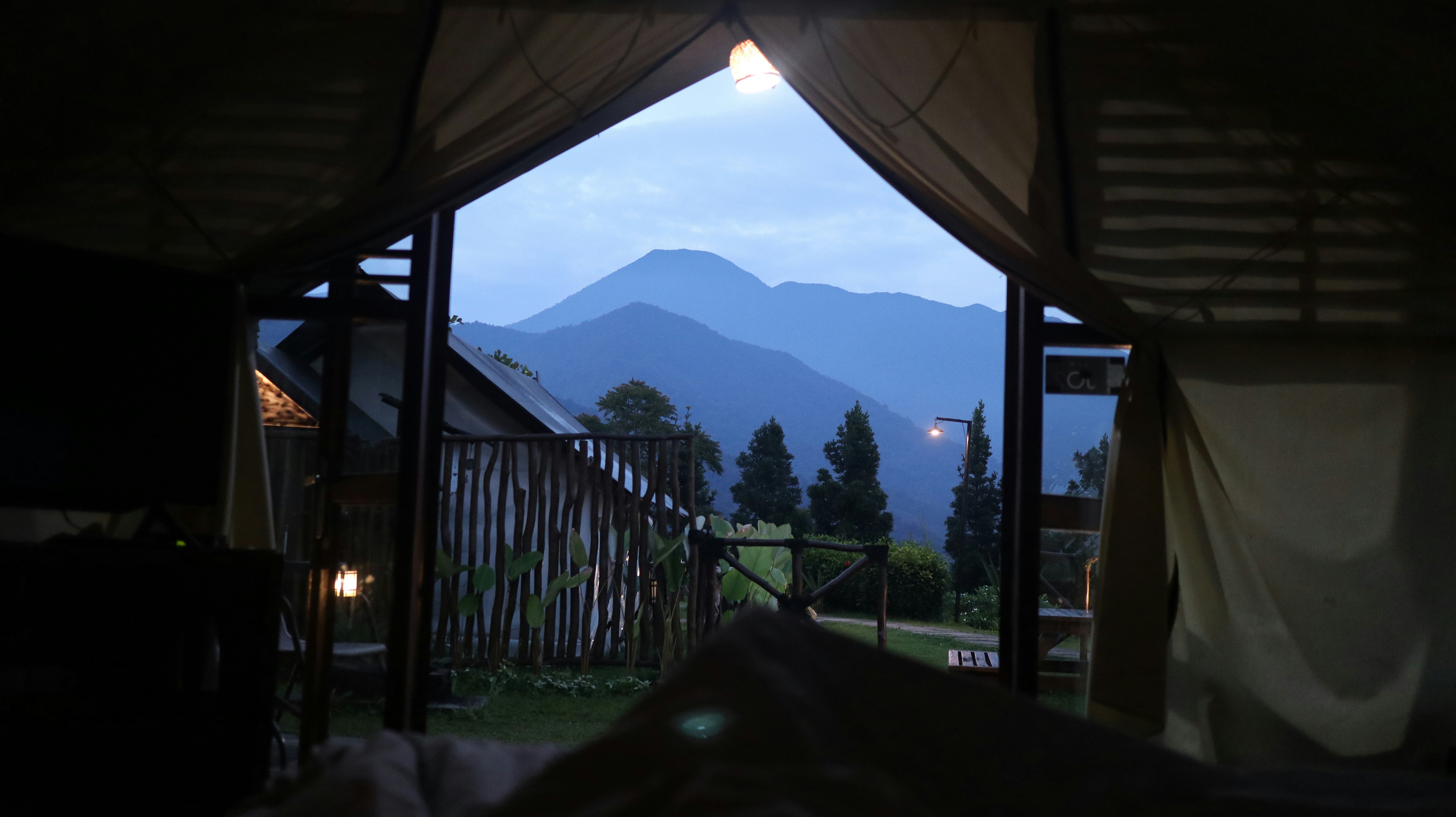 View of mountains from inside a tent at dusk