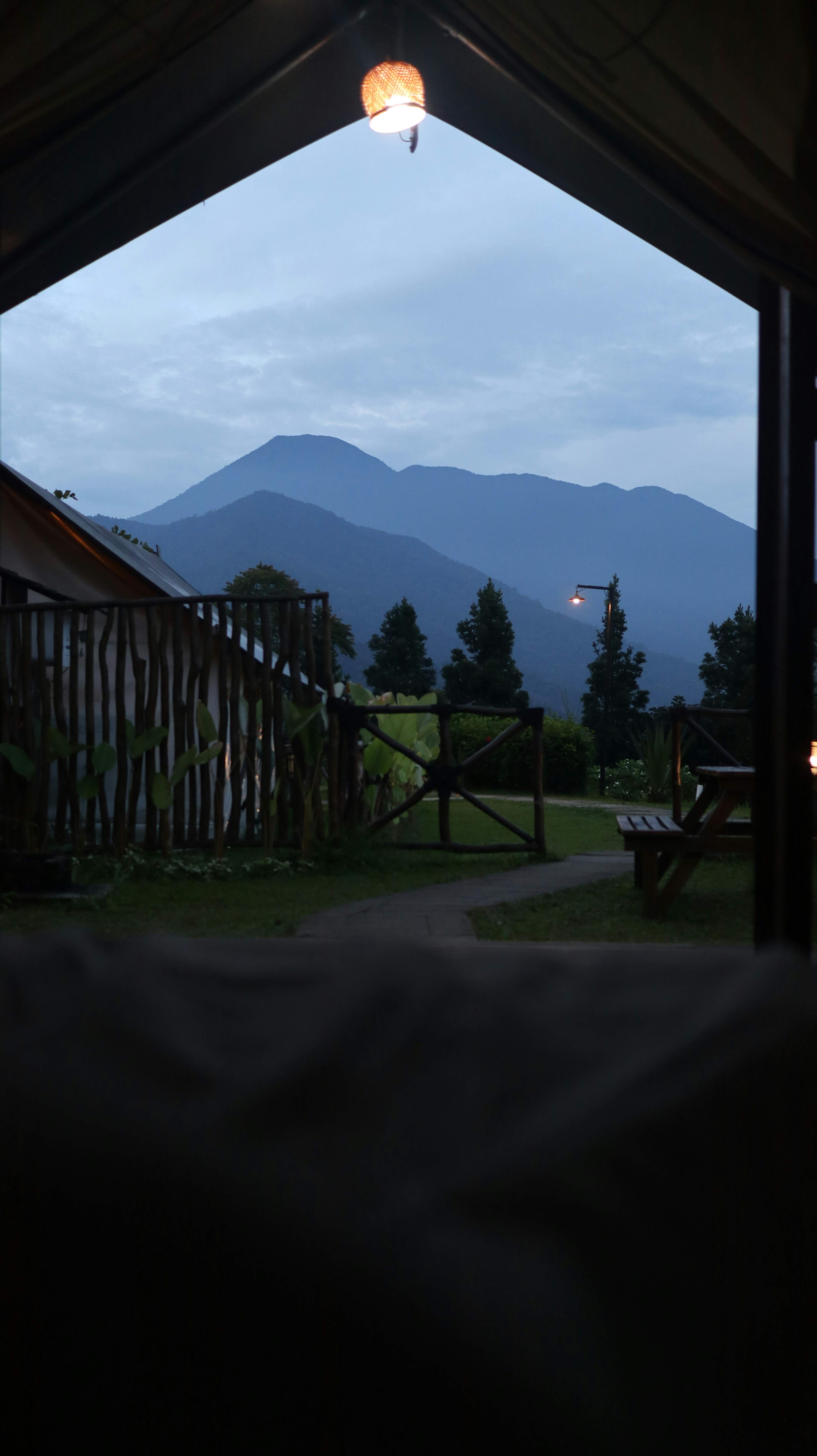 Layered mountains visible through a rustic outdoor setting.