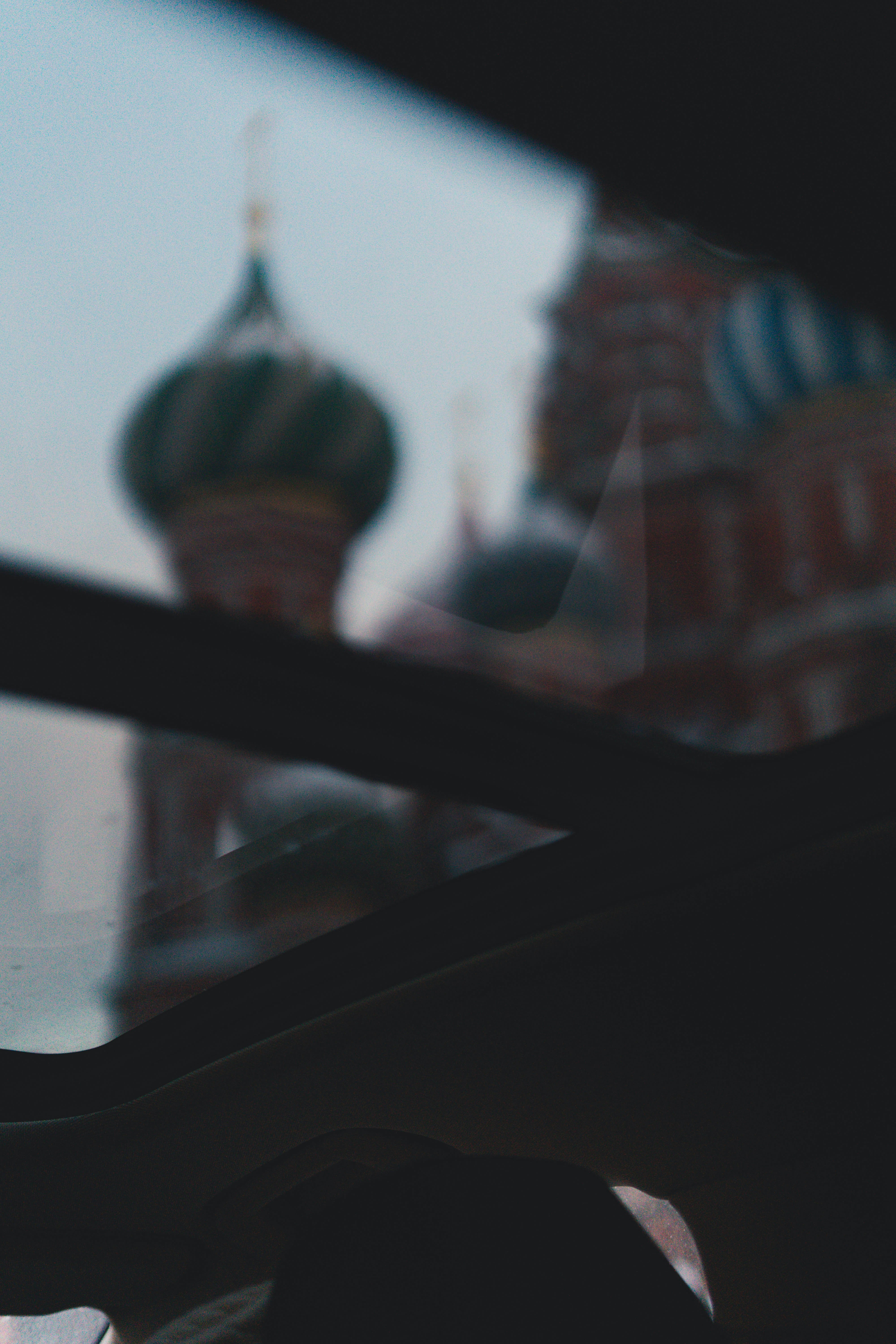 Blurred view of colorful domed church through window