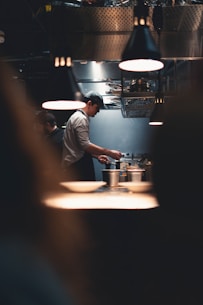 Chef cooking in a professional kitchen at night