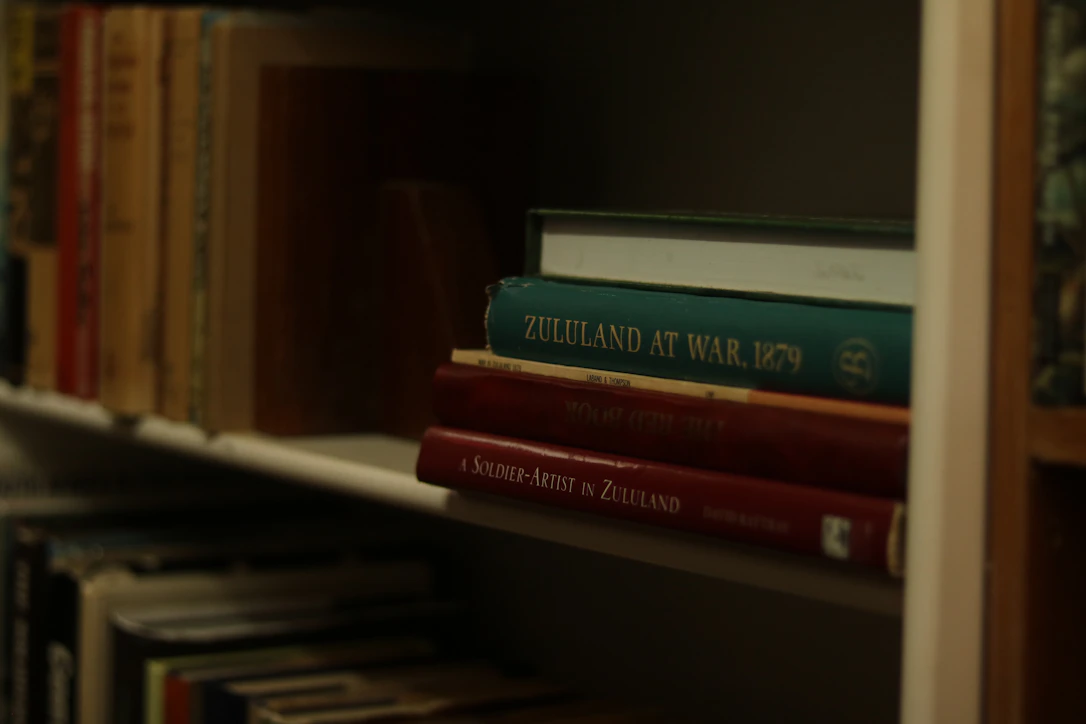 Stack of books on a shelf with titles visible