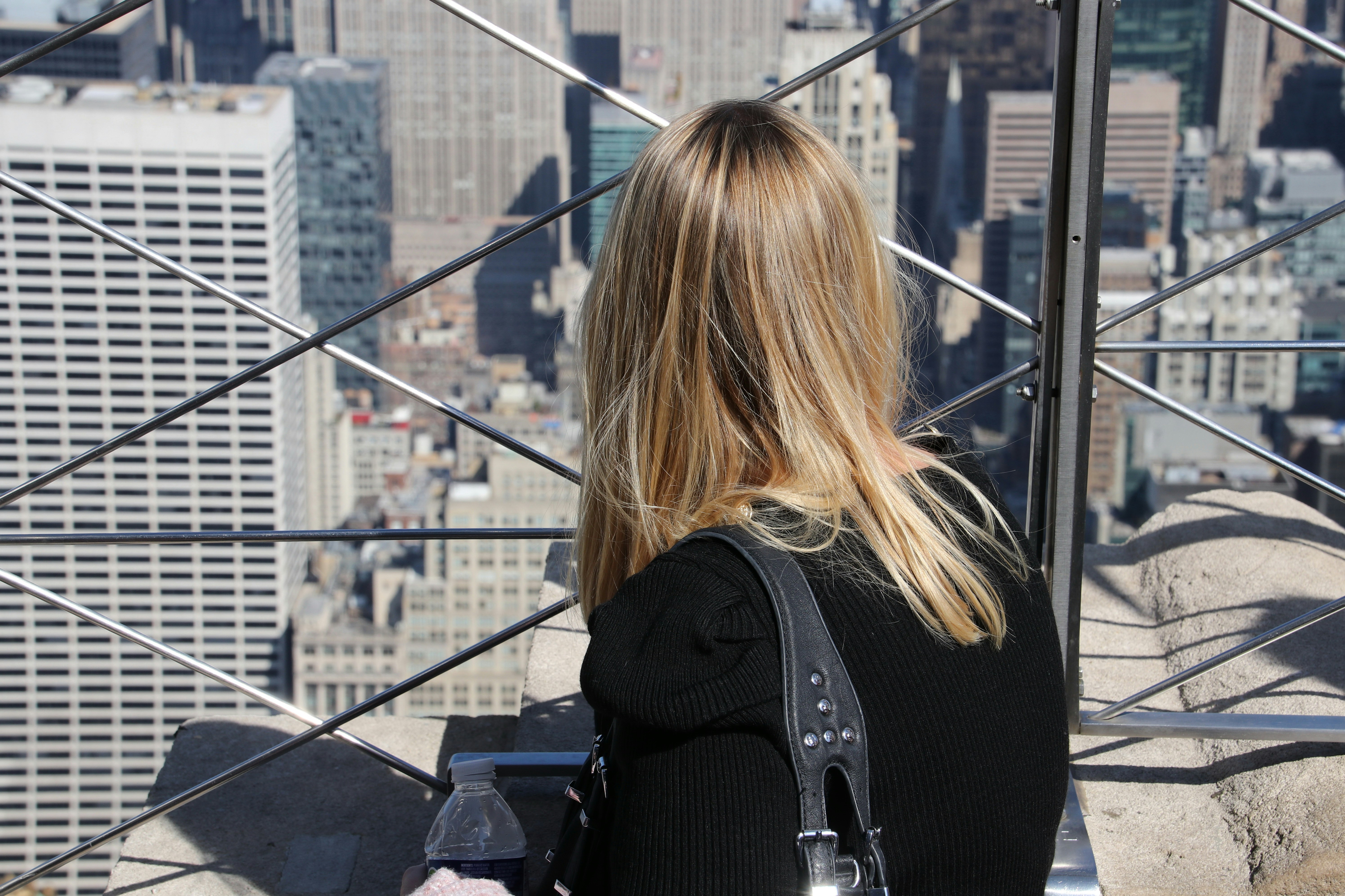 Woman looking out at a cityscape from above