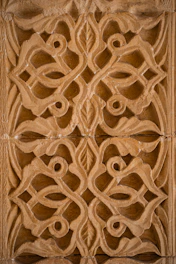 Intricate carved stone pattern with floral motifs.