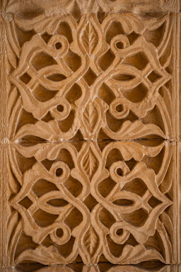 Intricate carved stone pattern with floral motifs.