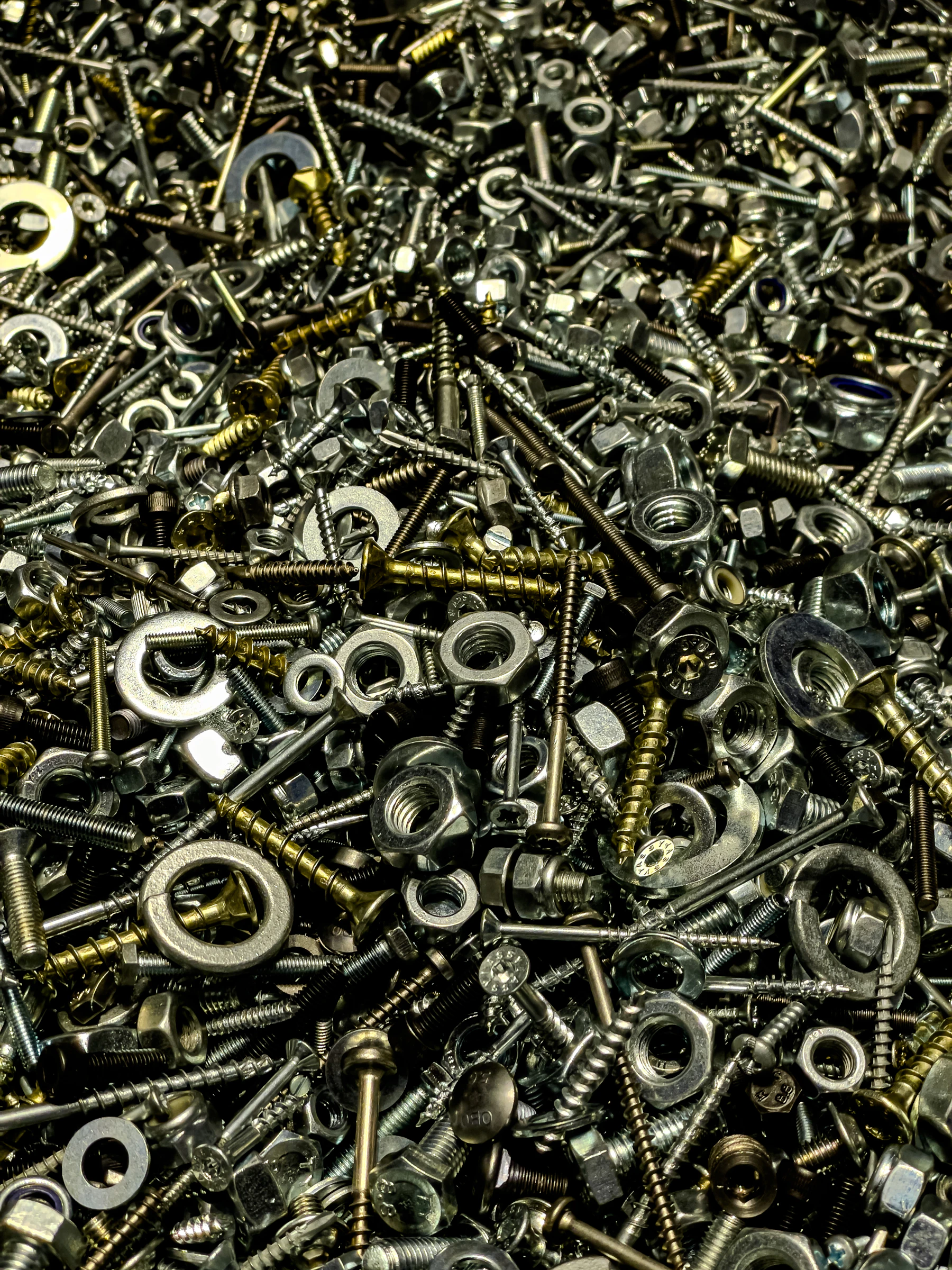 Assorted nuts bolts washers and screws prepared for hardware and repair work