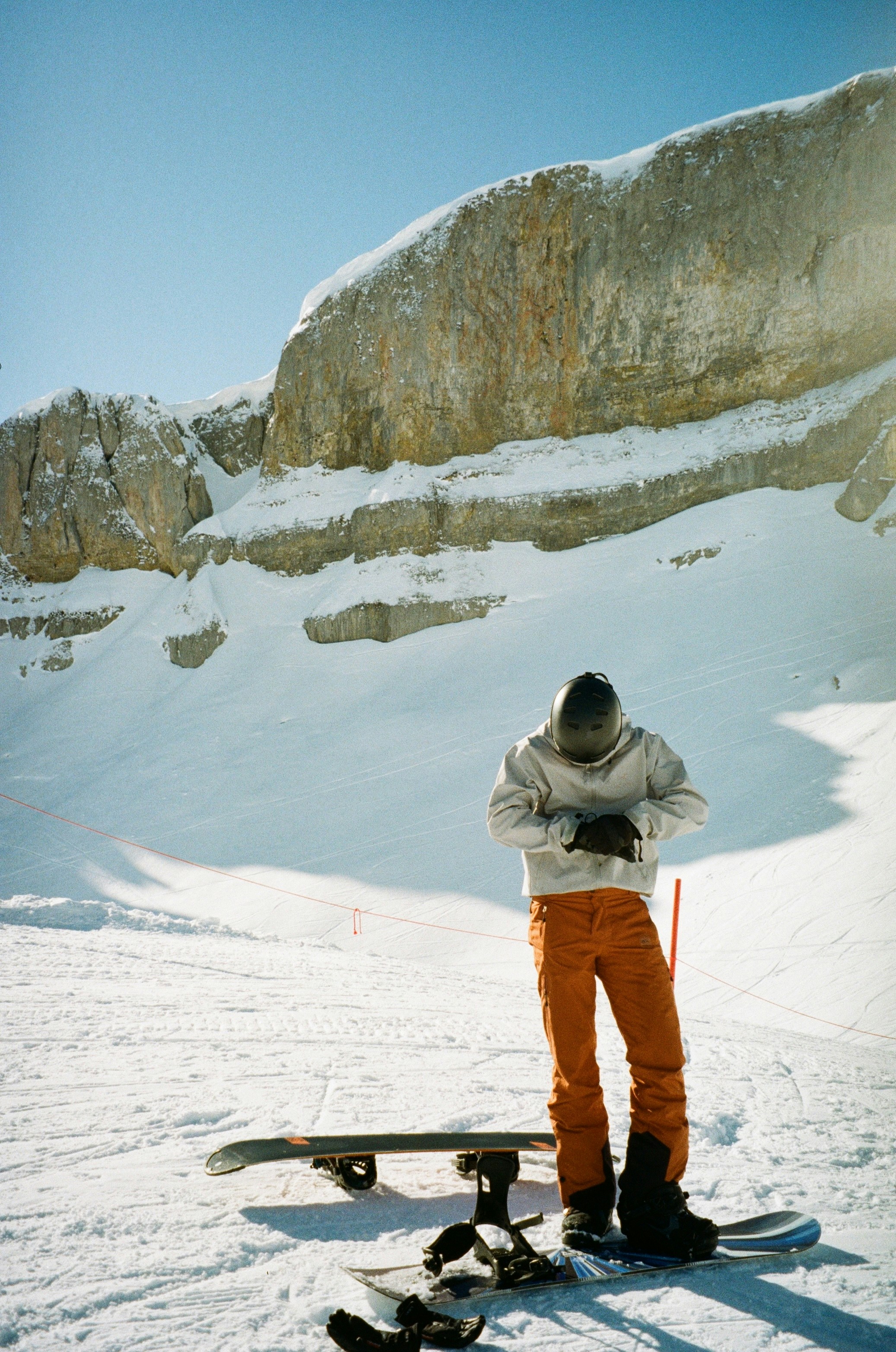 Snowboarder preparing on a snowy mountain slope.