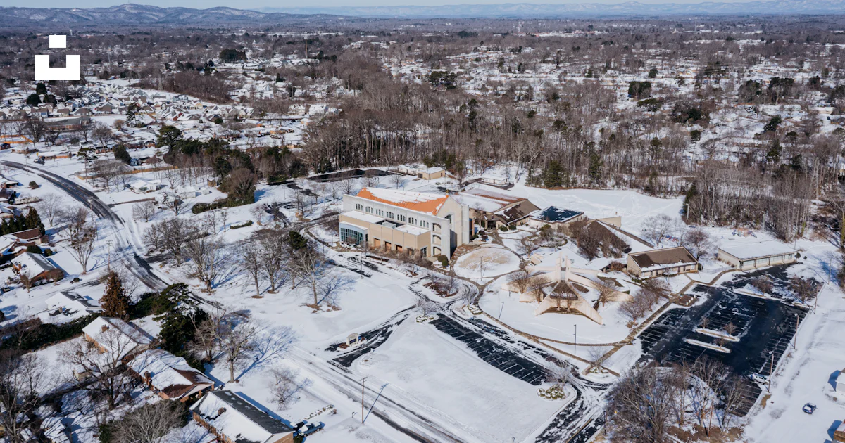 Aerial view of buildings and trees covered in snow photo – Free ...