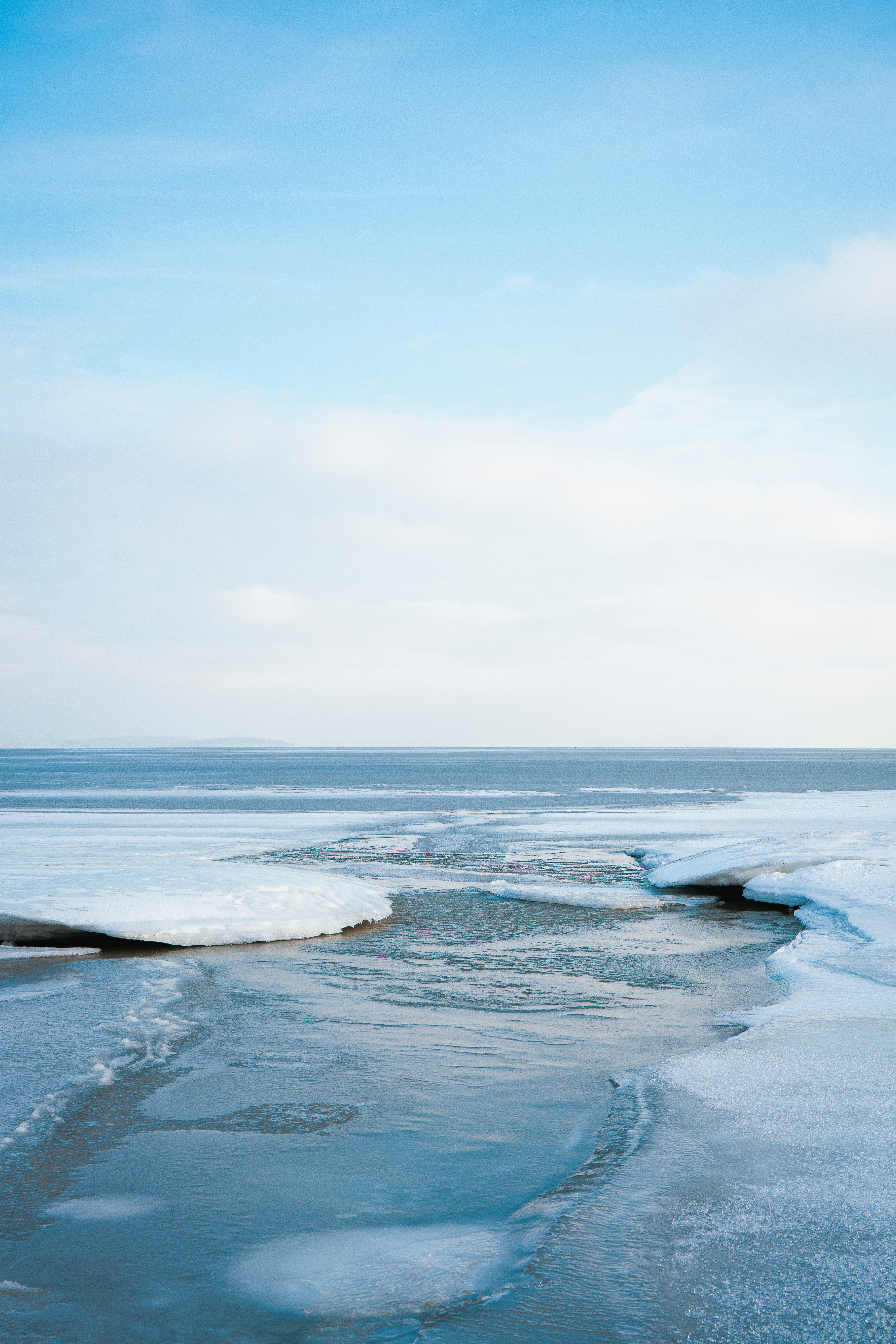 Frozen landscape with ice formations and calm water