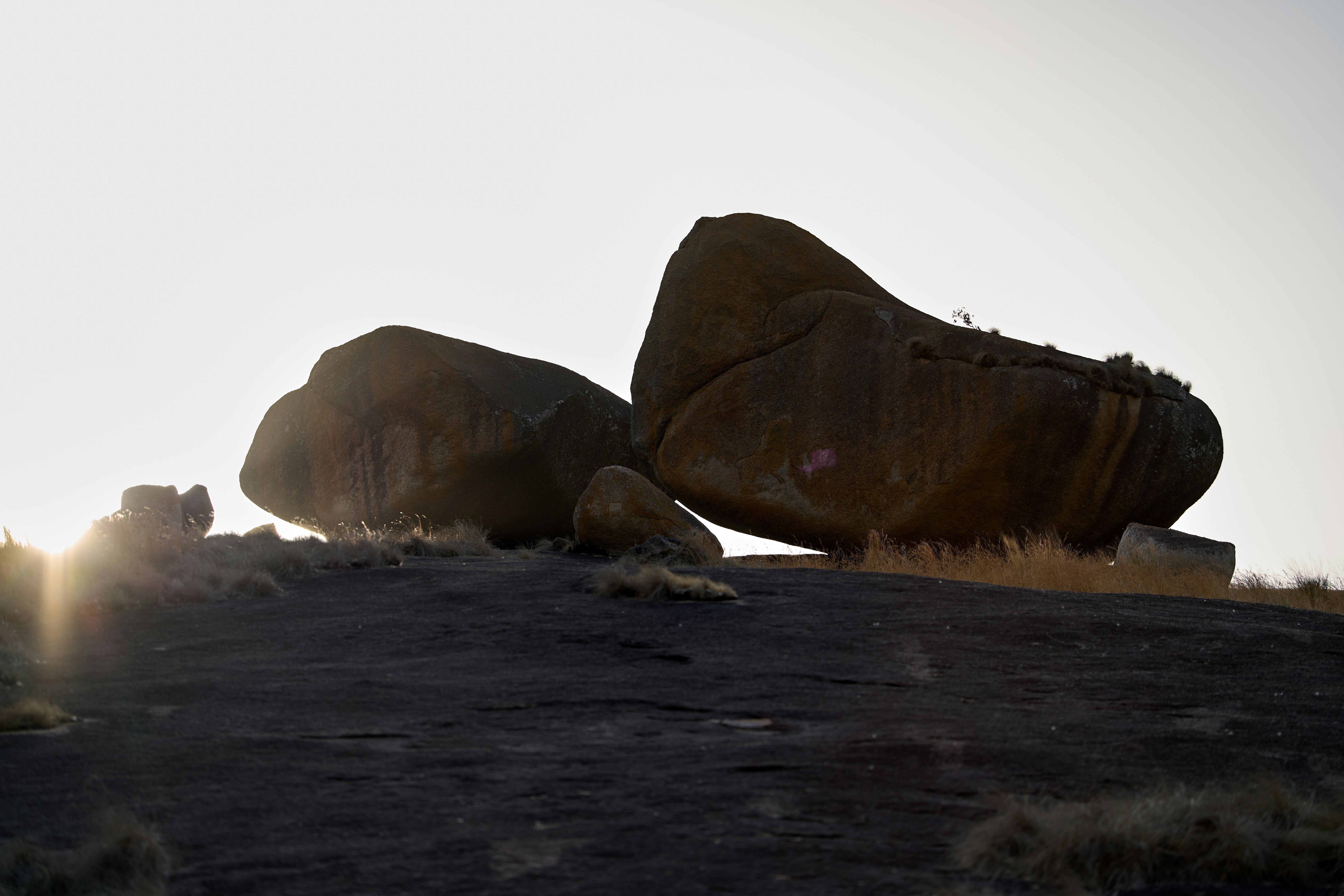 Large boulders on a rocky hilltop at sunset