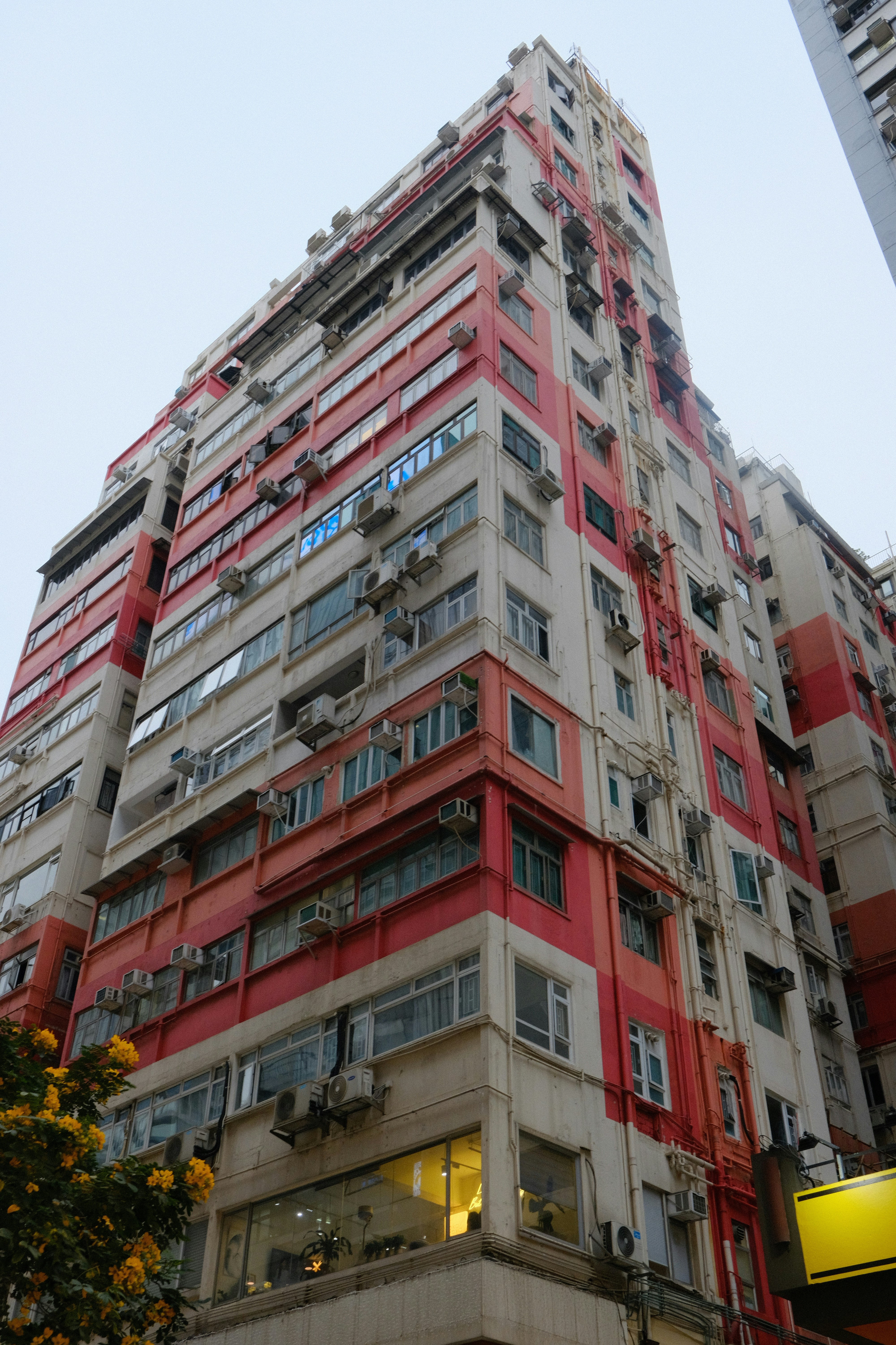 Tall apartment building with red and white stripes.