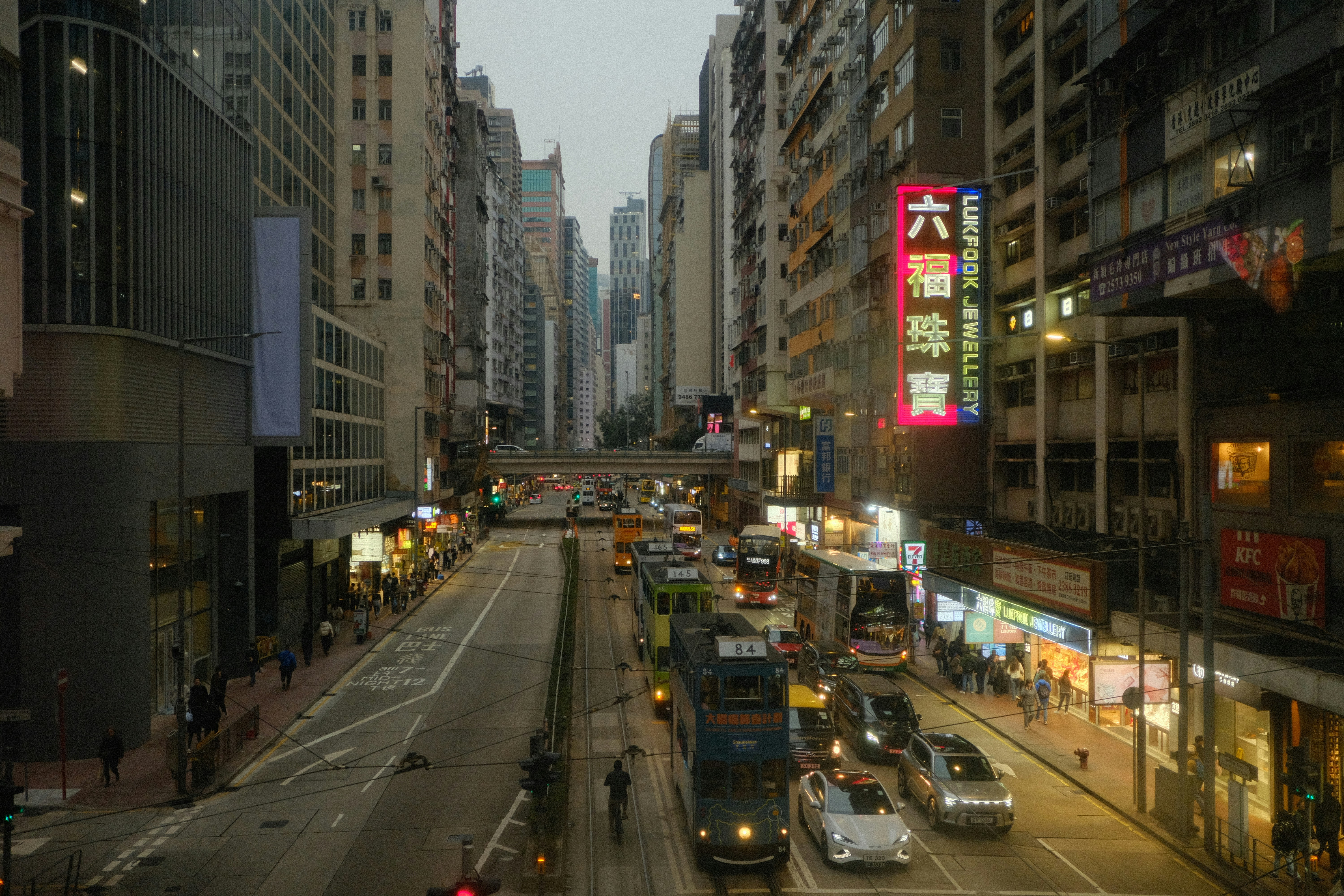Busy city street with traffic and neon signs