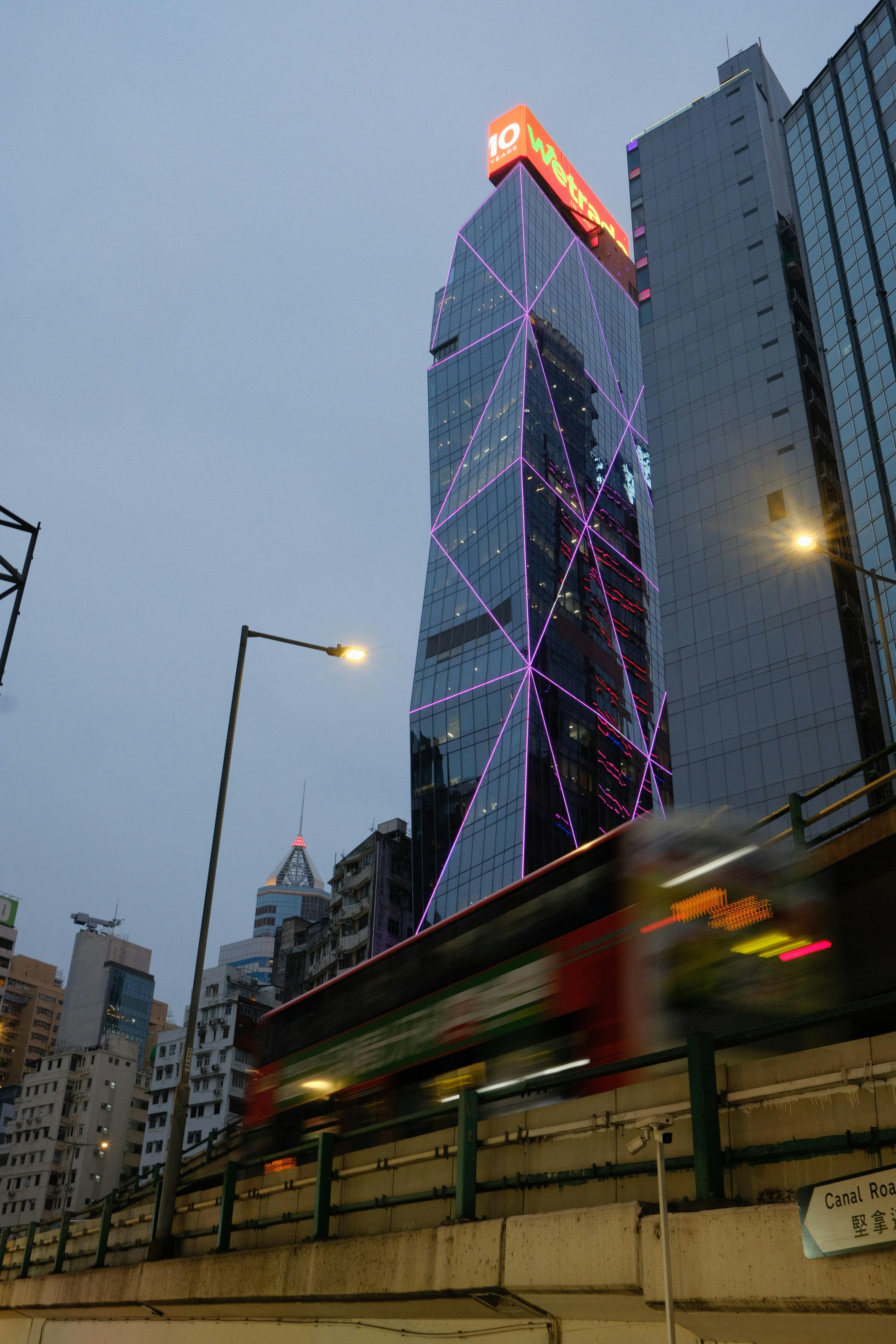 Modern skyscrapers with a blurred bus passing by.