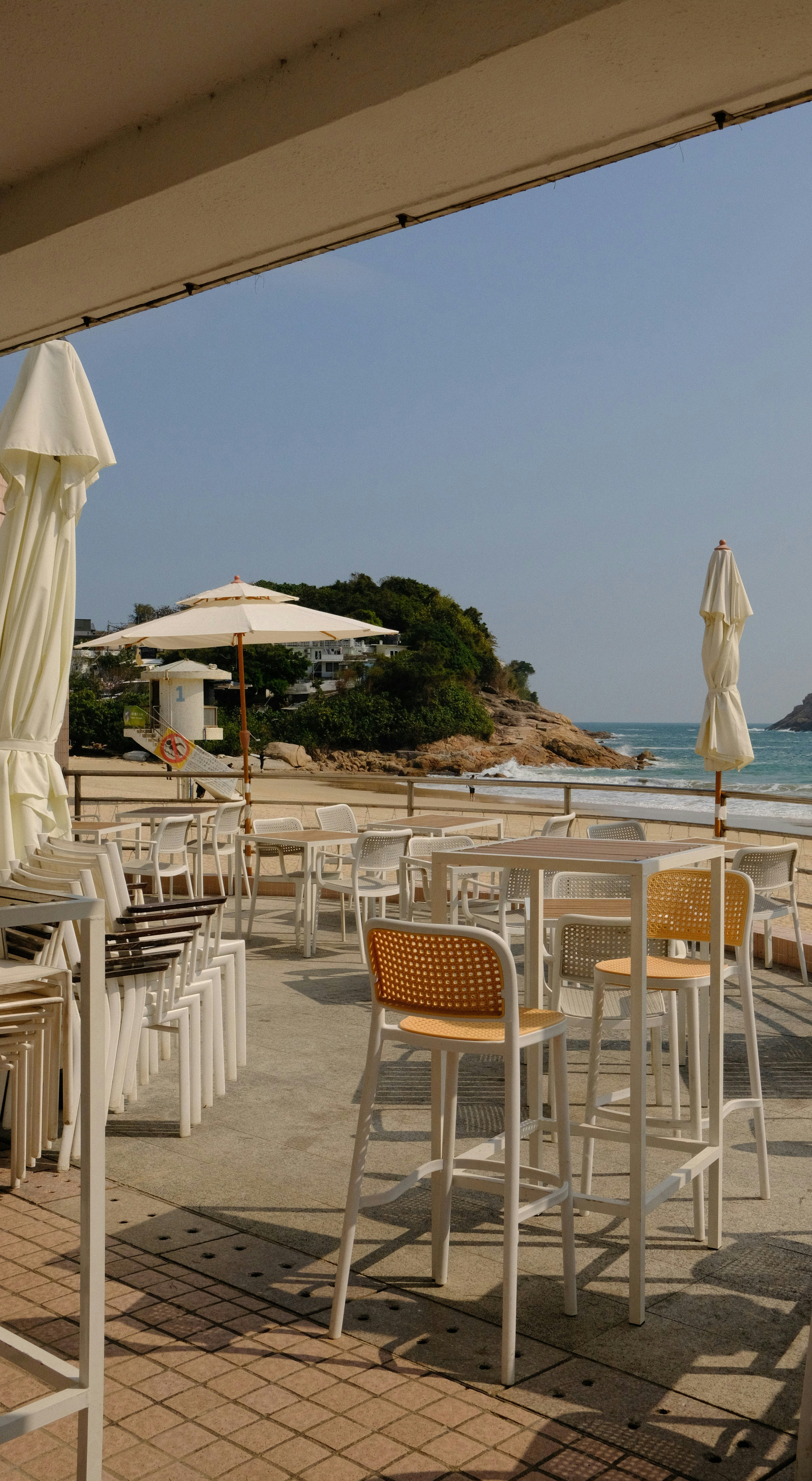 Outdoor cafe seating with beach and ocean view