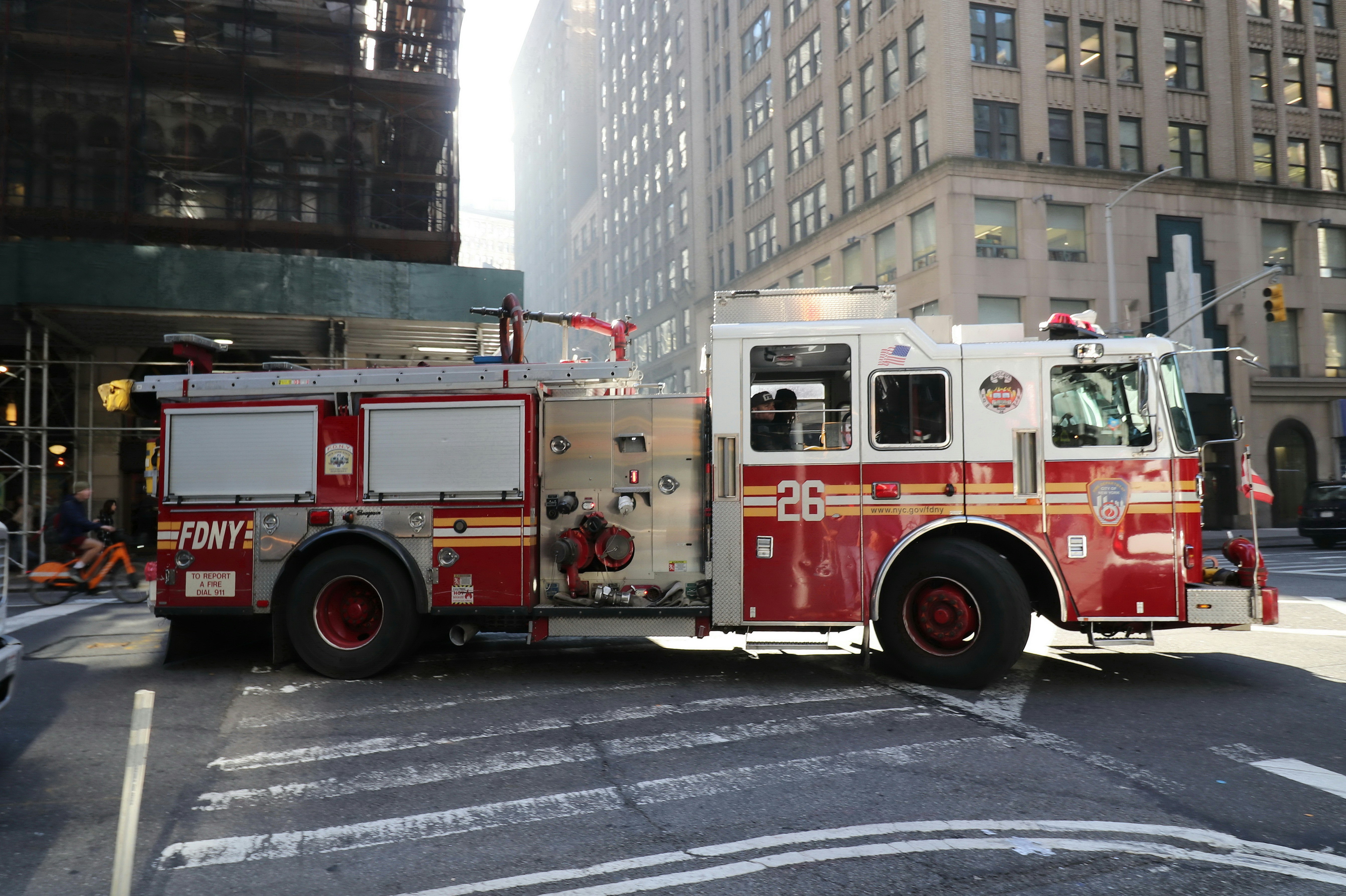 A red and white fire truck parked on city street.