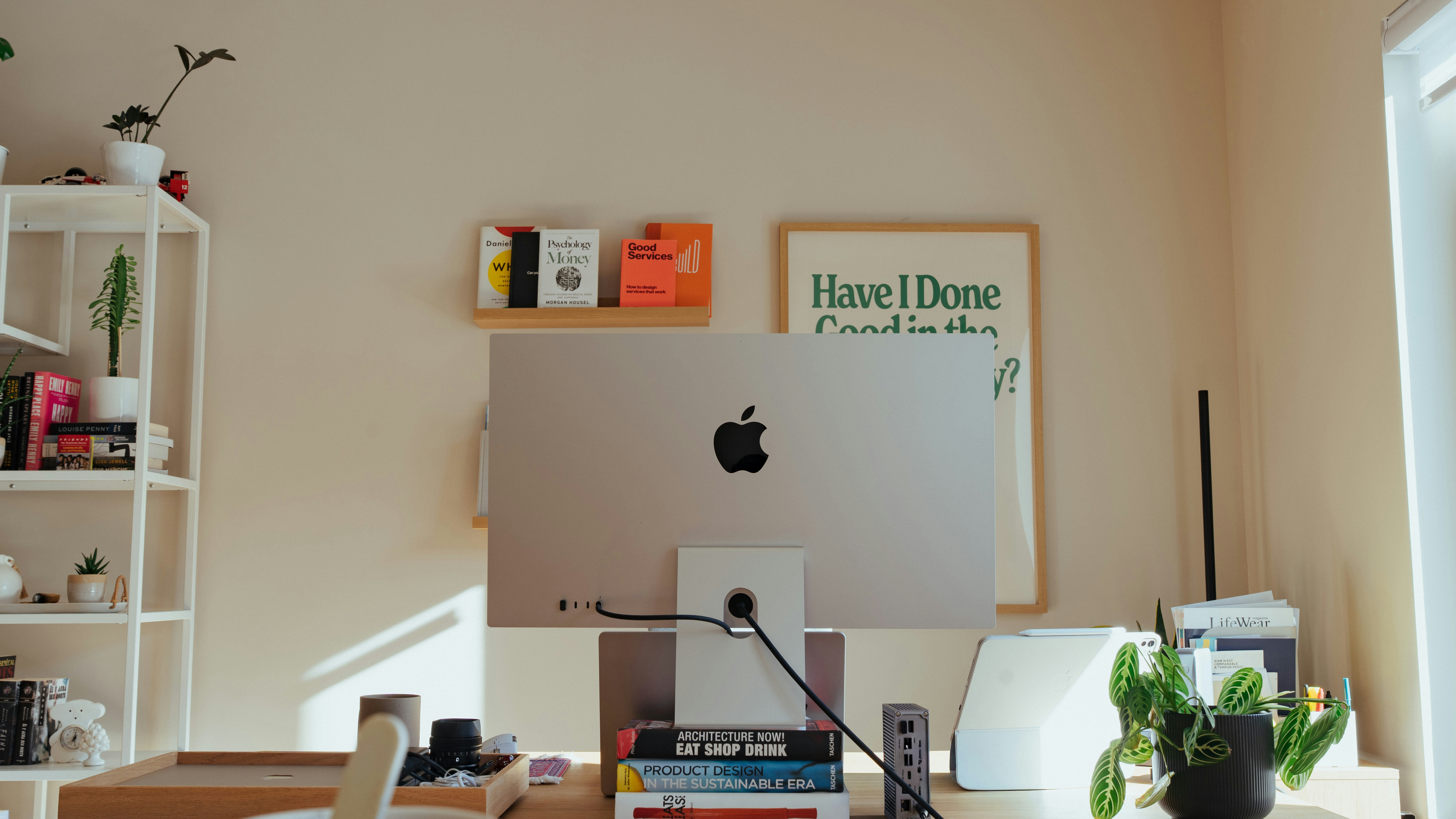 Desk with apple computer and plants.