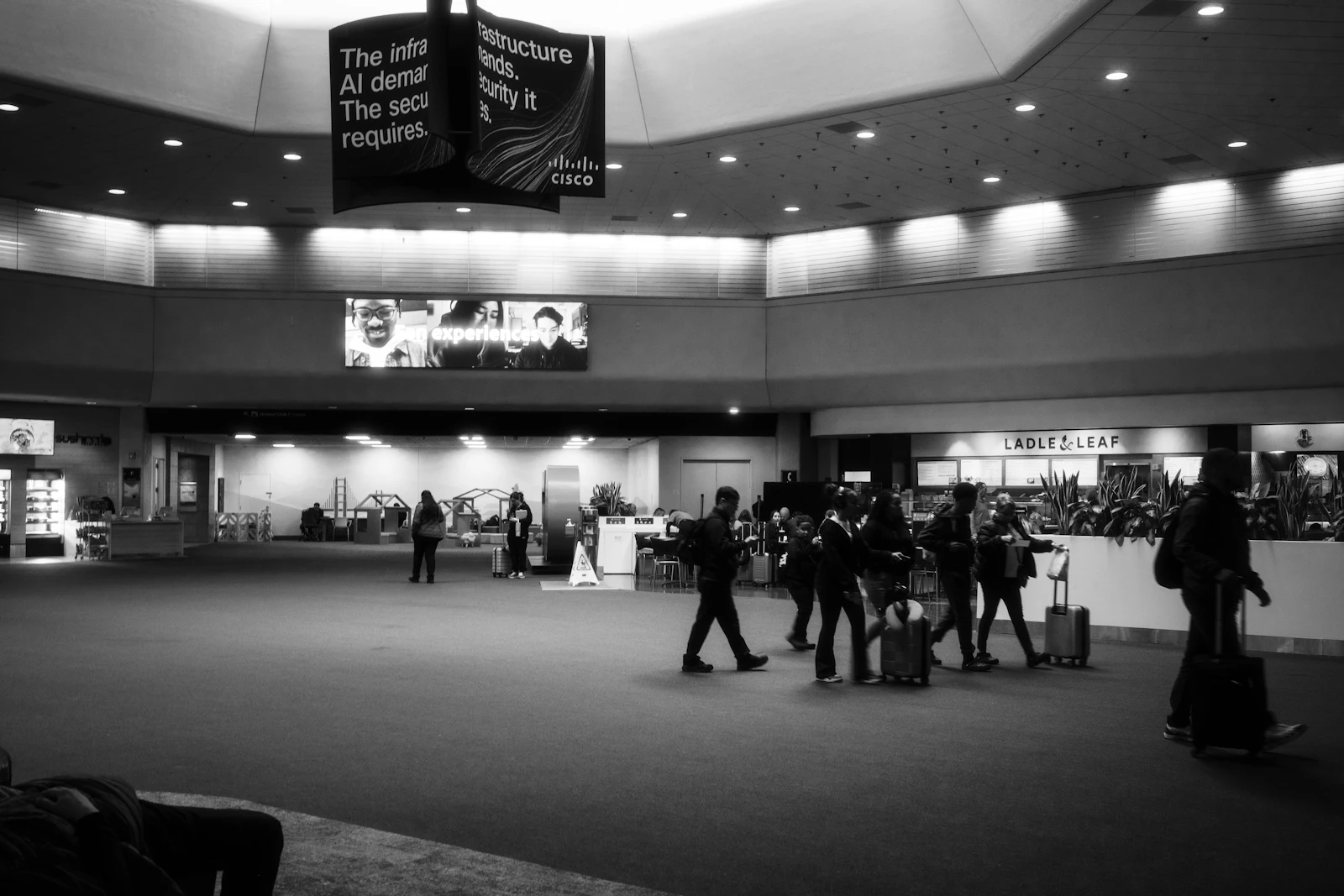 Travellers with luggage inside a modern airport terminal