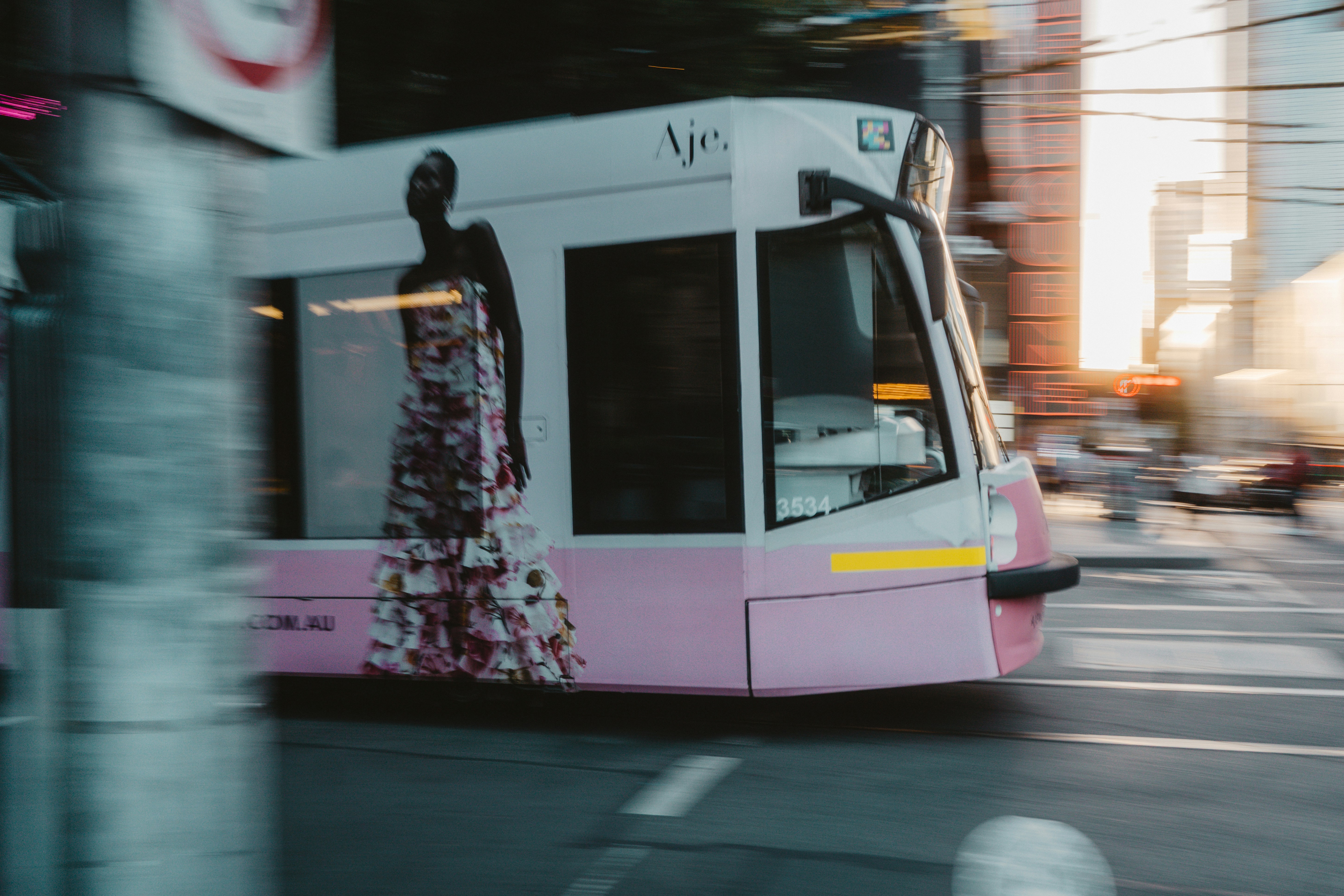 A tram moves quickly through a city street.