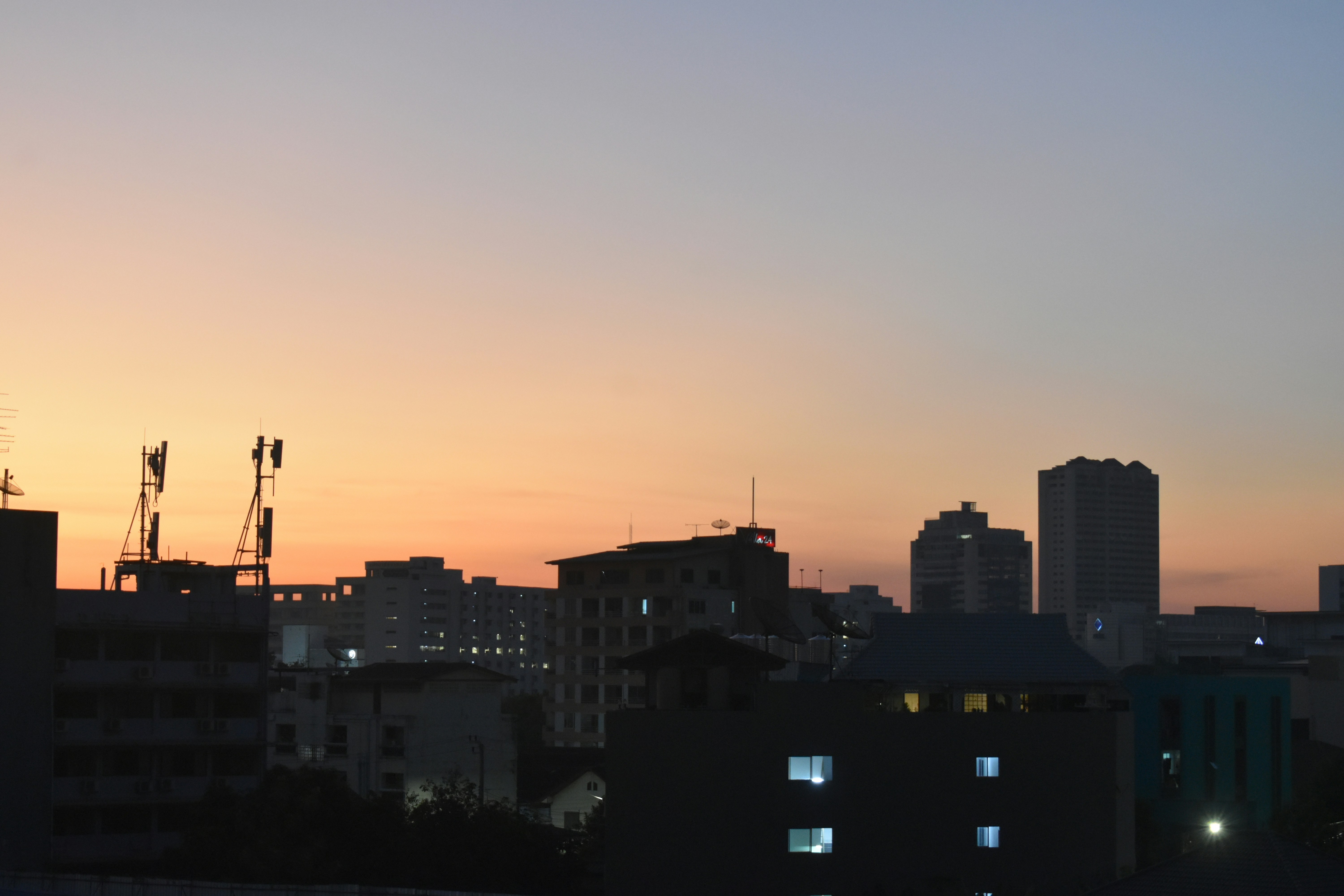 City skyline at sunset with colorful sky.