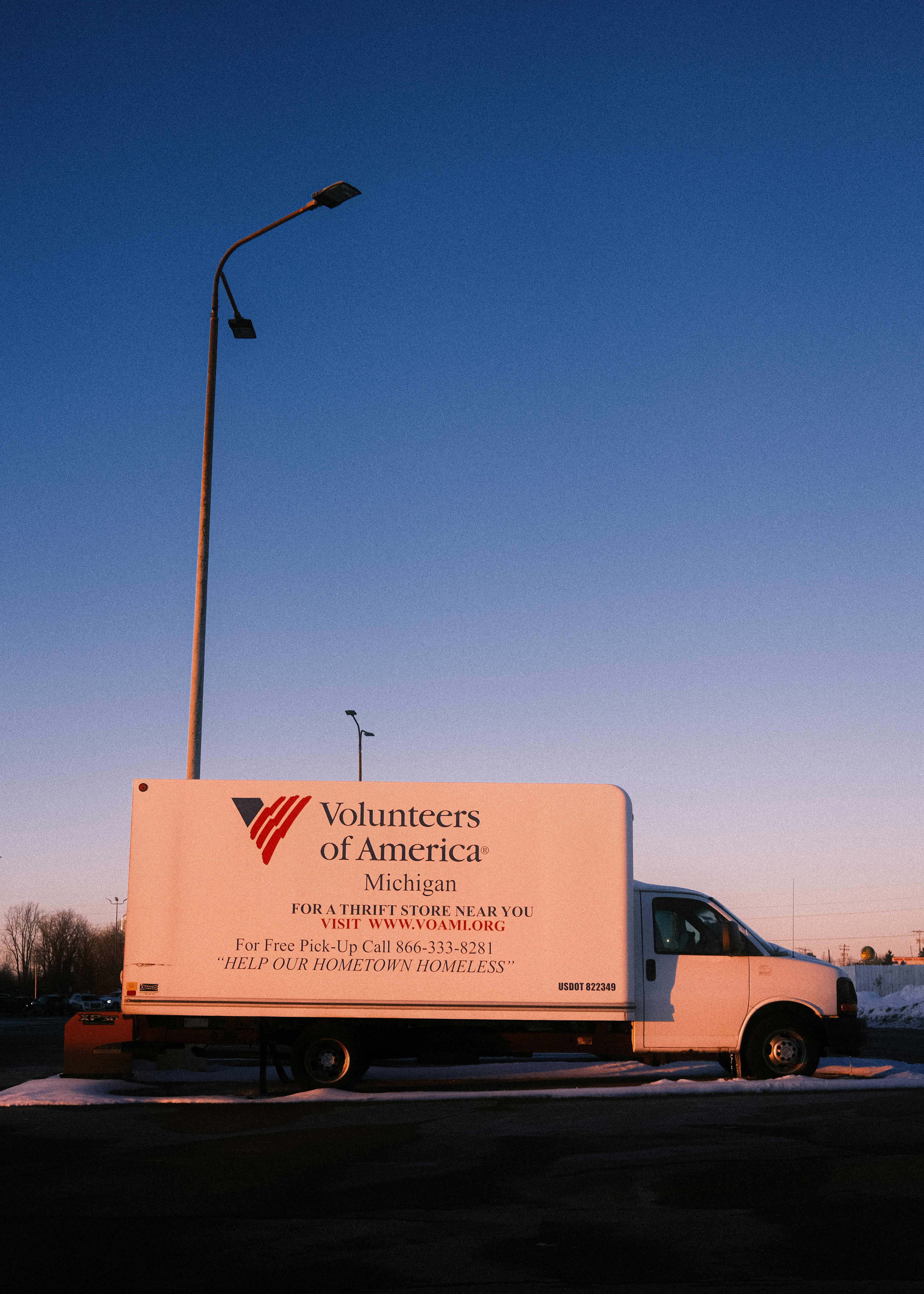 White truck with volunteers of america logo