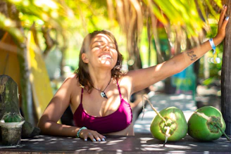 Woman enjoying sunshine with coconuts