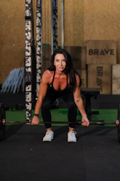 Woman lifting a barbell in a gym