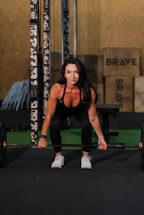 Woman lifting a barbell in a gym