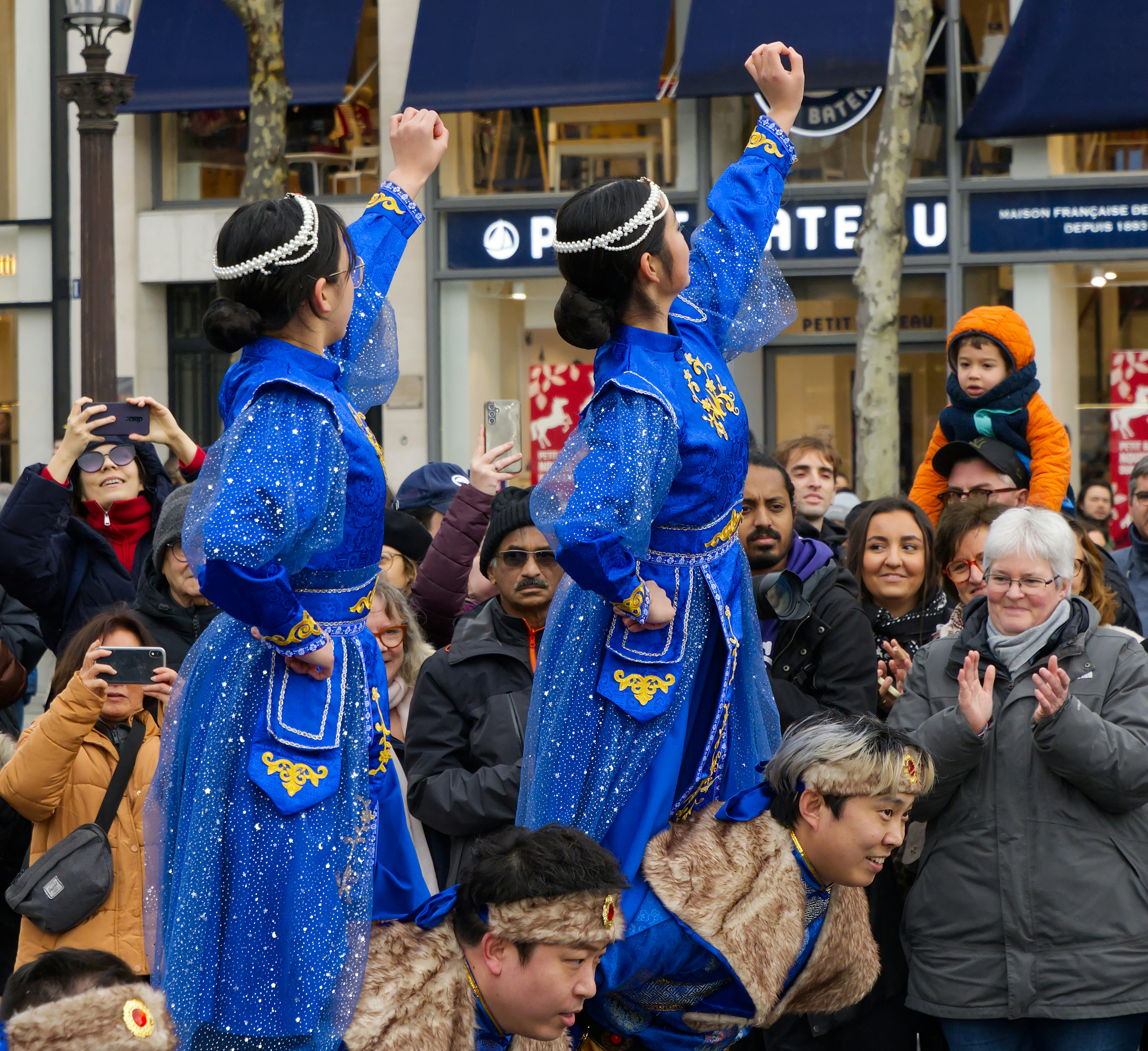 Two women in blue traditional outfits dancing