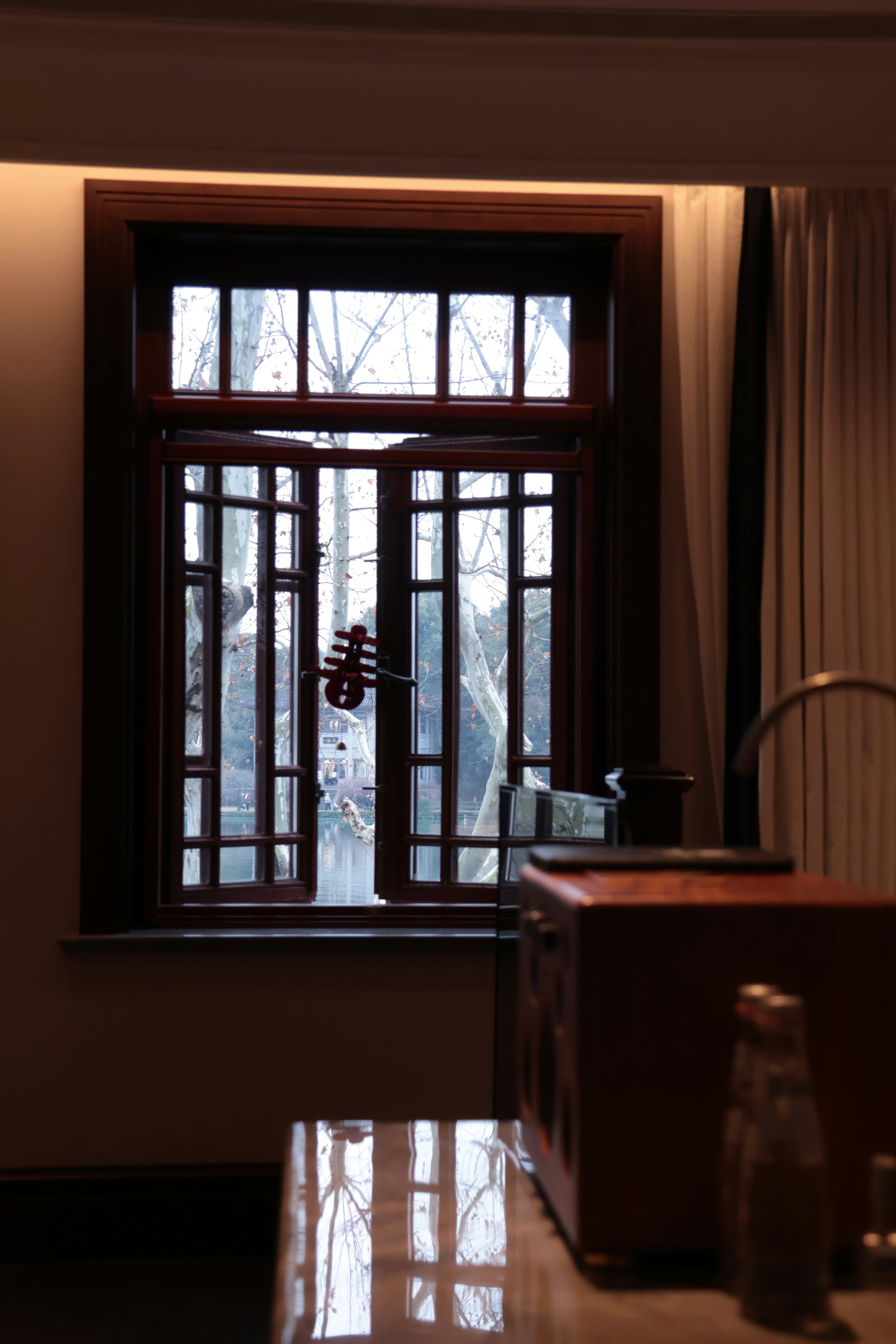 Open window with a view of bare trees outside