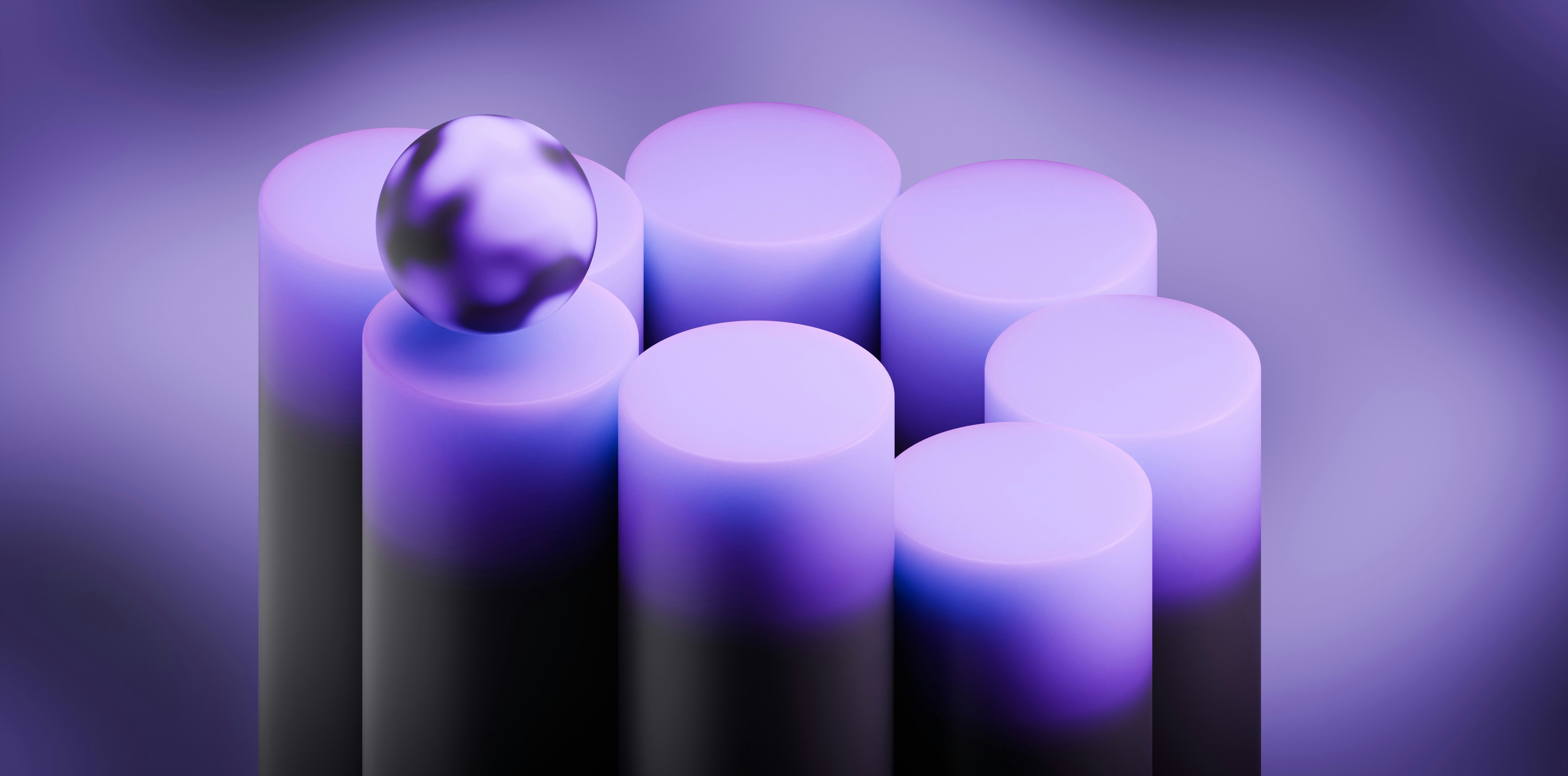 A metallic sphere rests on a purple cylinder.