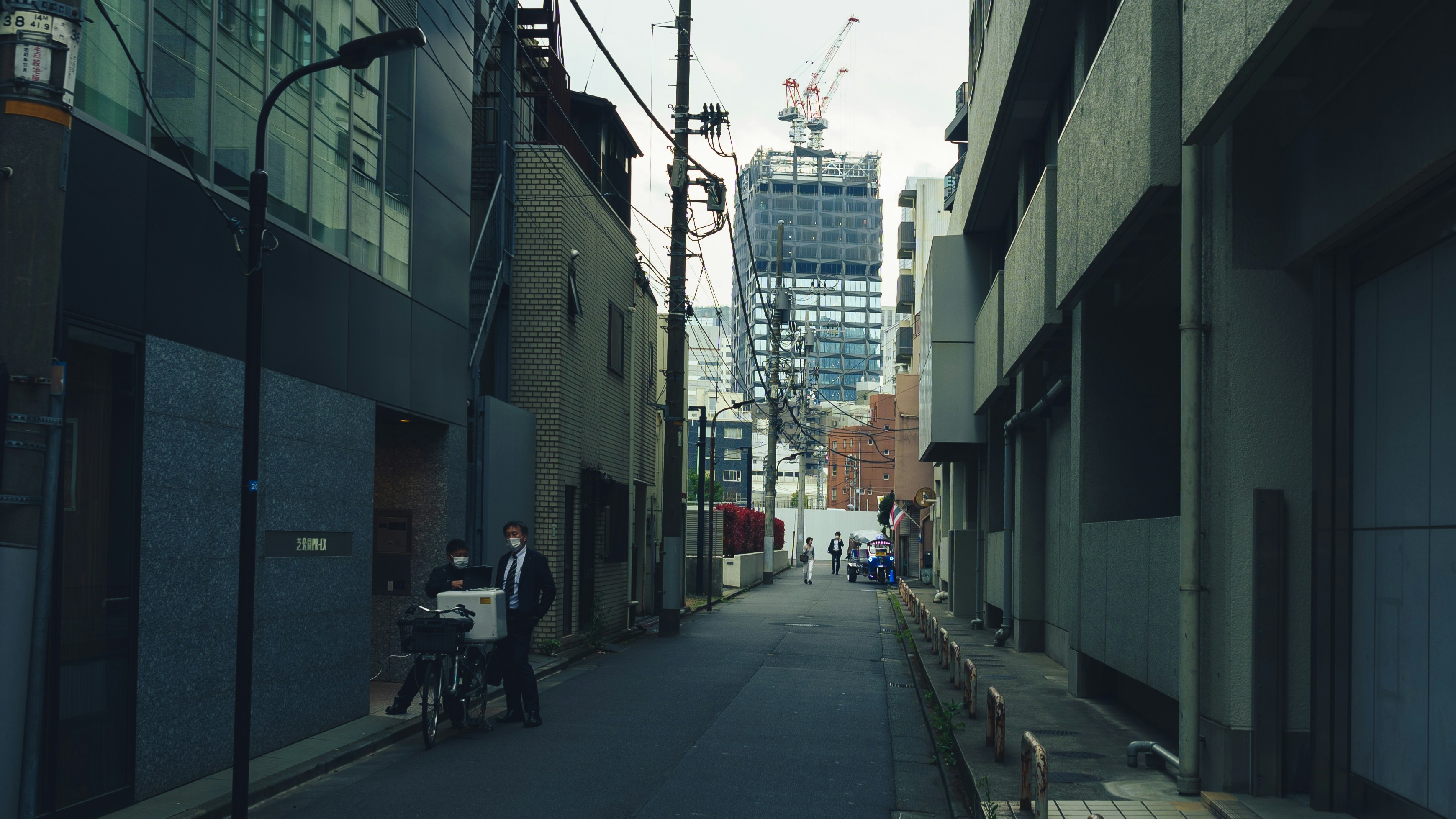 Narrow alleyway with buildings and construction in distance
