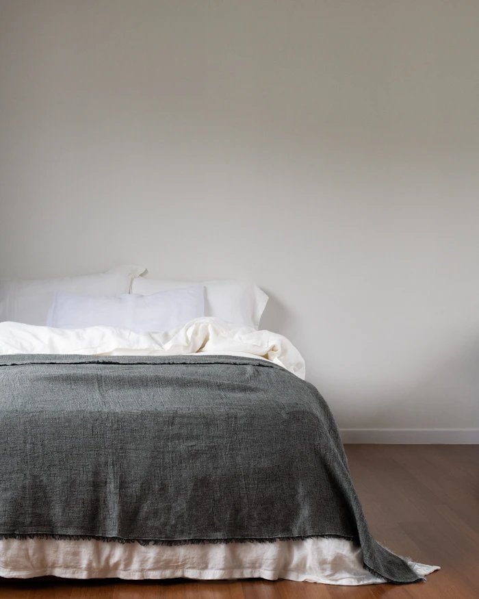 Washed linen bedding in soft daylight