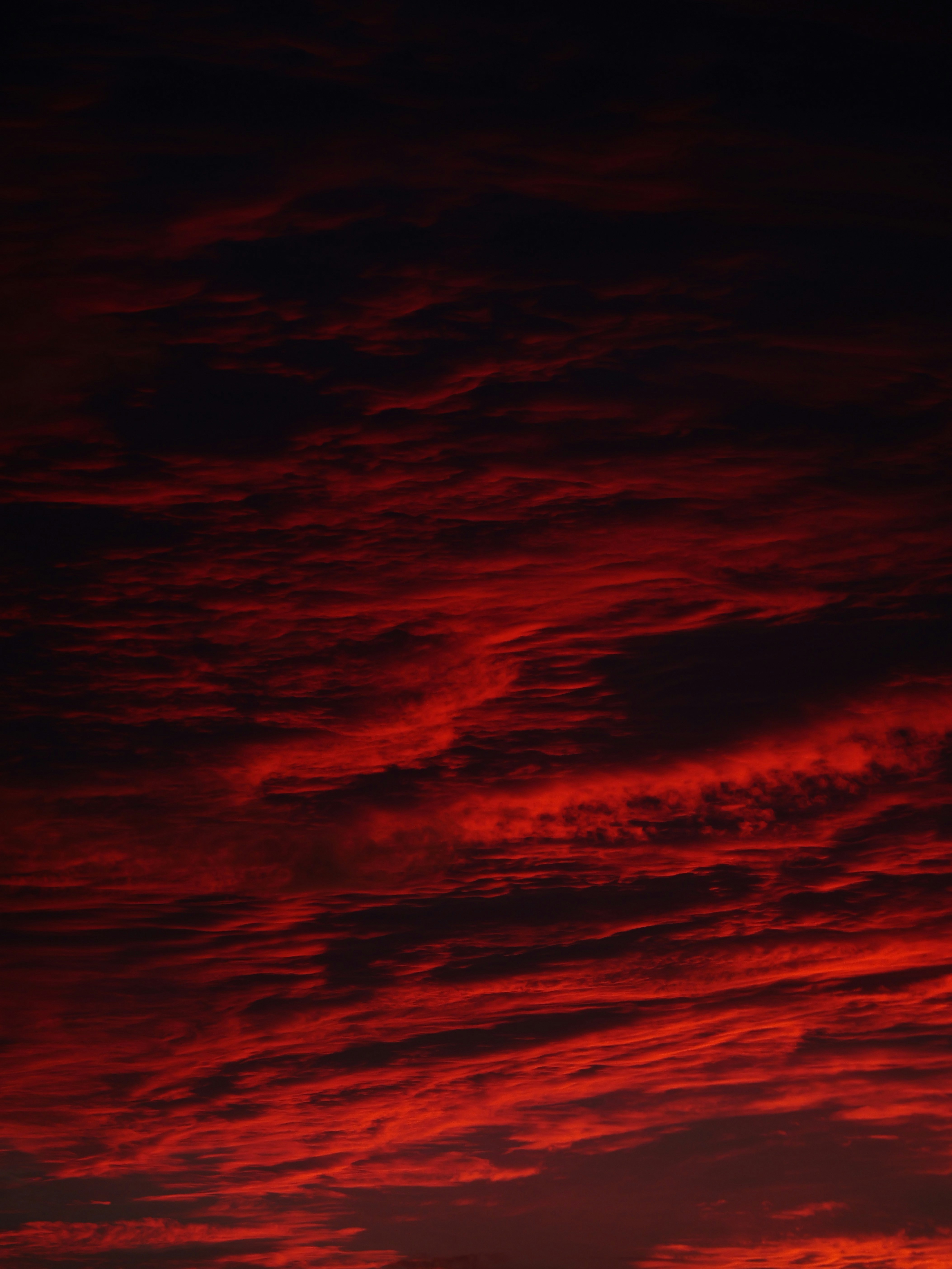 Dramatic red clouds fill the dark sky