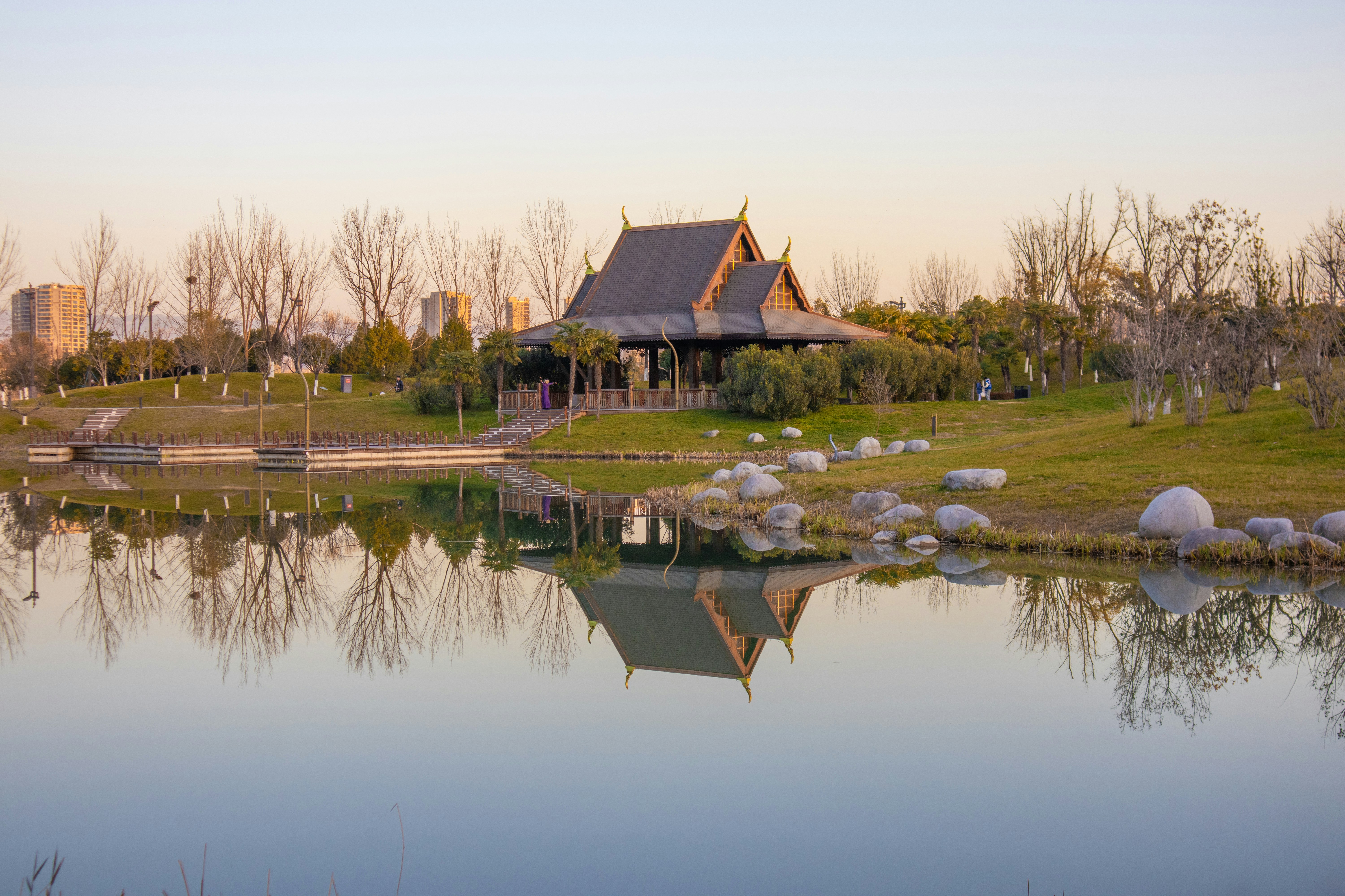Traditional building reflected in calm water at sunset