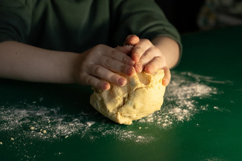 Baker's hands kneading fresh dough