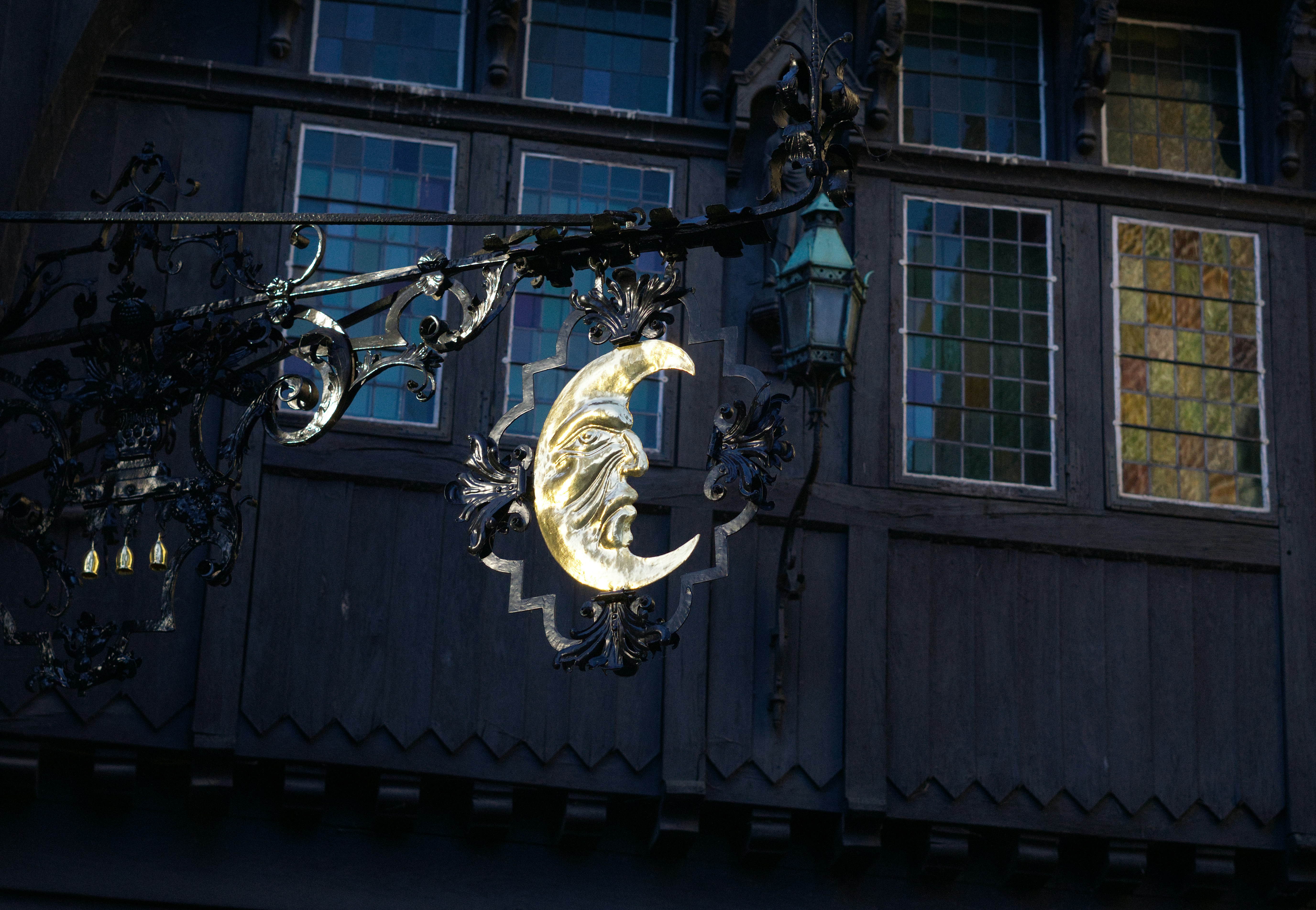 Ornate crescent moon sign hanging outside building