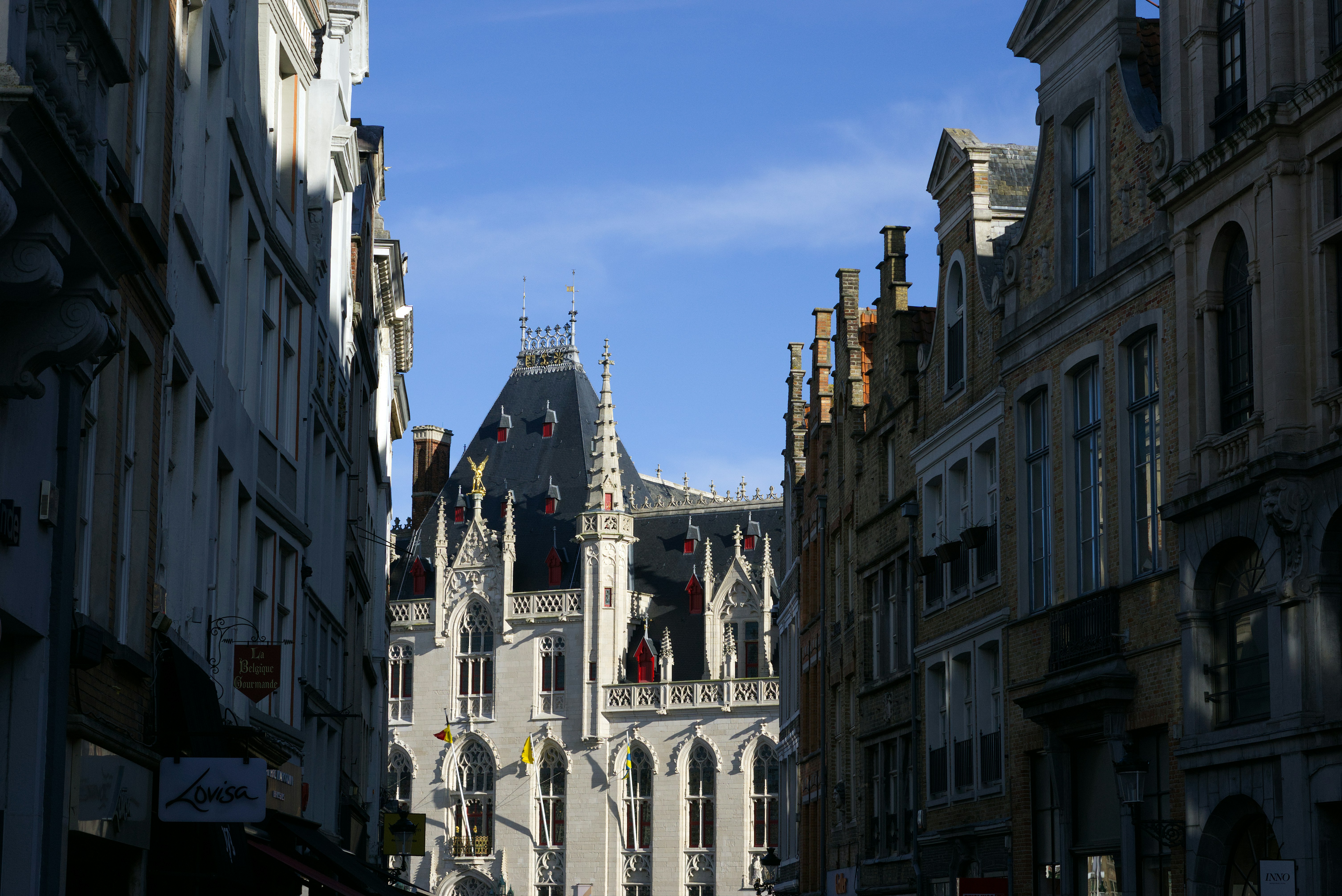 Historic european street with ornate architecture under blue sky